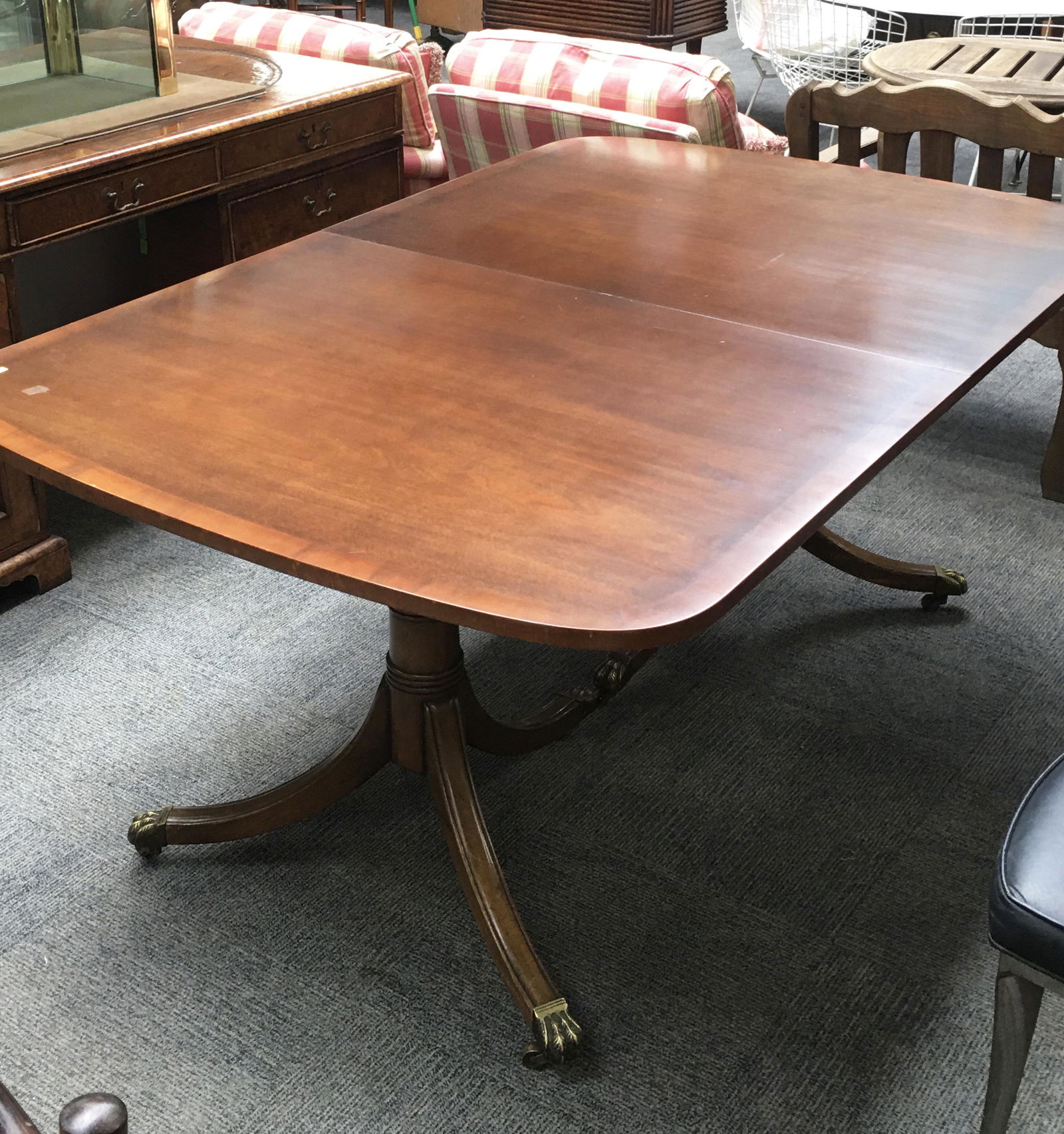 Signed Kittinger Mahogany Dining Table.: Comes with Two Leaves (Not Pictured). The Surface of the Table has some Light Scratches. Table Surface Measures 44" x 68". Third-Party Freight Shipping or Personal Pickup Required.