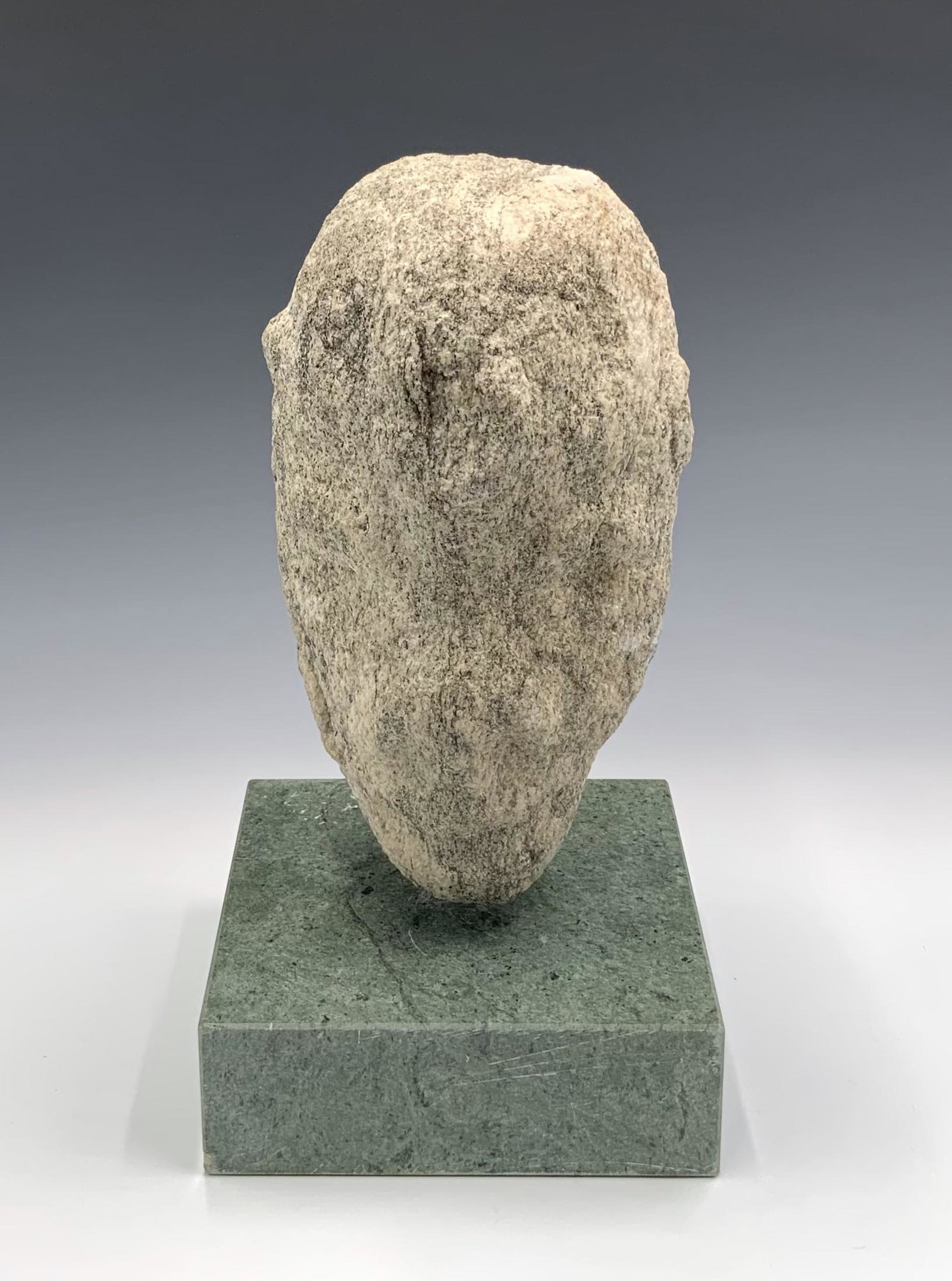 Stone-Carved Sculpture of Man's Head.: Age and Origin Unknown. Measures 9" Tall. It Rests on a Grey Marble Base (with Scratches and Dinks). Height of the Sculpture, including the Base, Measures 11 1/4" Tall. Third-Party Shipping or Persona