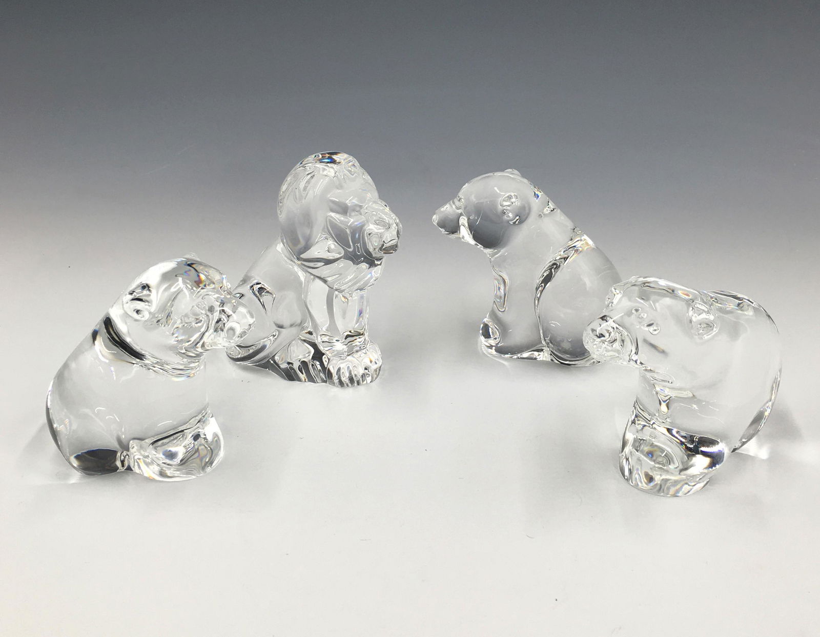 Lot of 4 Small Steuben Animal Figurines.: Includes 3 bears and one lion. 3 of them have the Steuben dust bags; all 4 have boxes. Bears are 2.25" tall, lion is 2.75" tall. All in very nice condition, with no damage noted. Third-Party Shipping