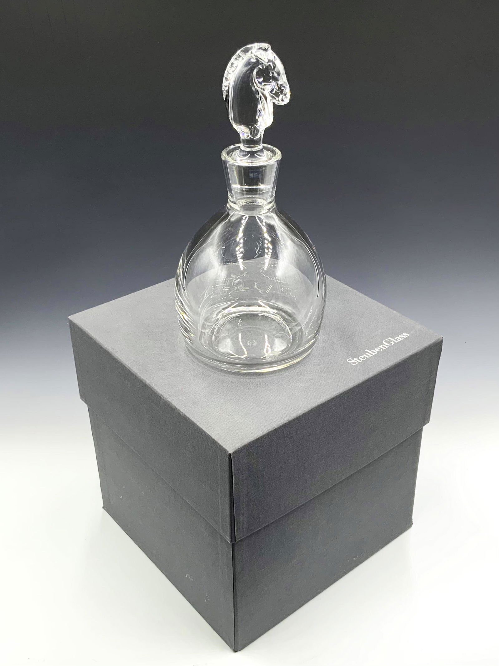 Steuben Decanter w/ Horse Head Stopper.: Comes w/ original box. Measures 10.5" tall, including stopper. Very nice condition, with no damage noted. Third-Party Shipping or Personal Pickup Required.