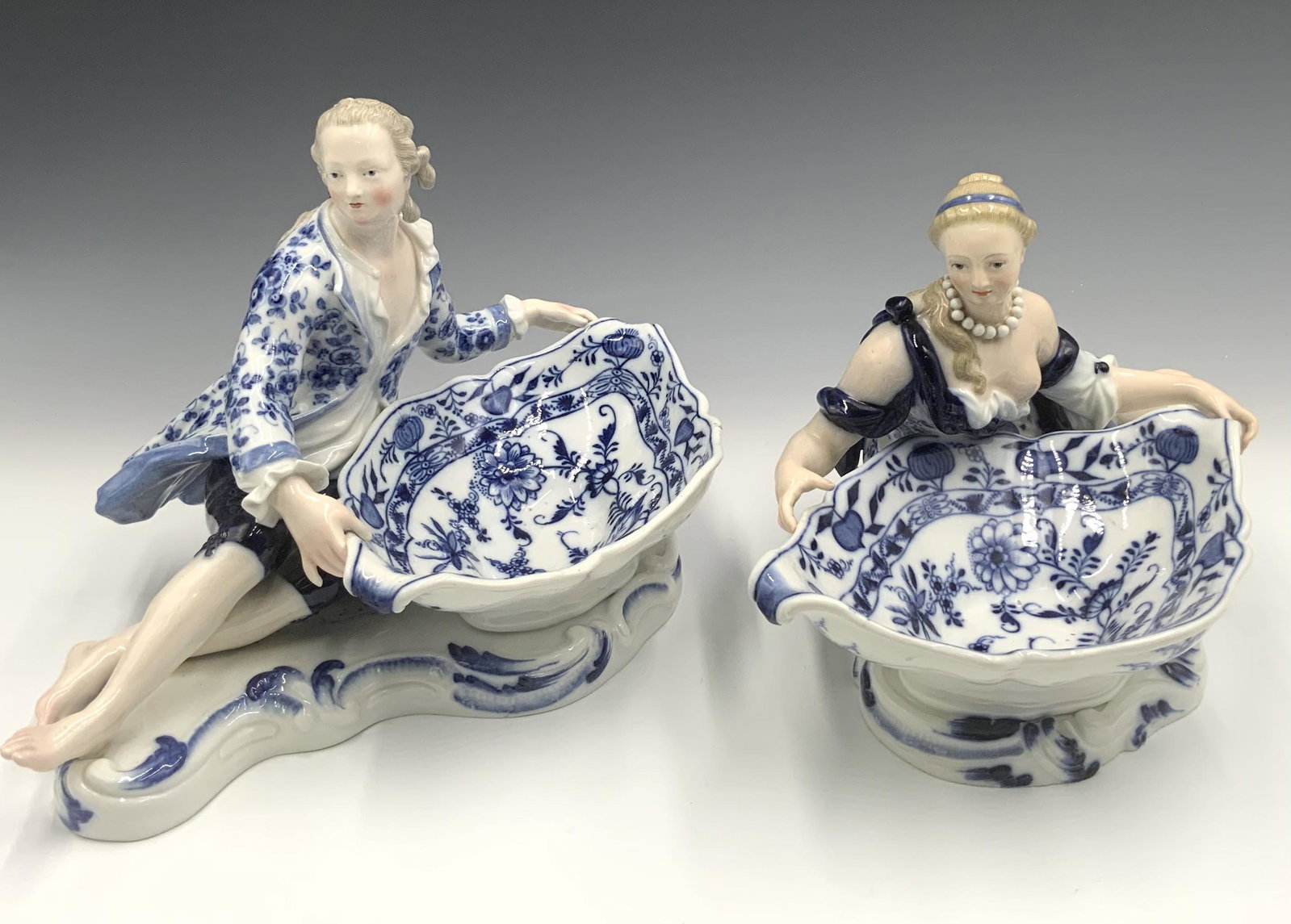 Pair of Meissen Figural Onion-Pattern Bowls.: These Measure 7" and 8" Tall, and 12" and 13" Wide. They are in Excellent Condition, but may have a Factory Defect here or there. Third-Party Shipping or Personal Pickup Required.