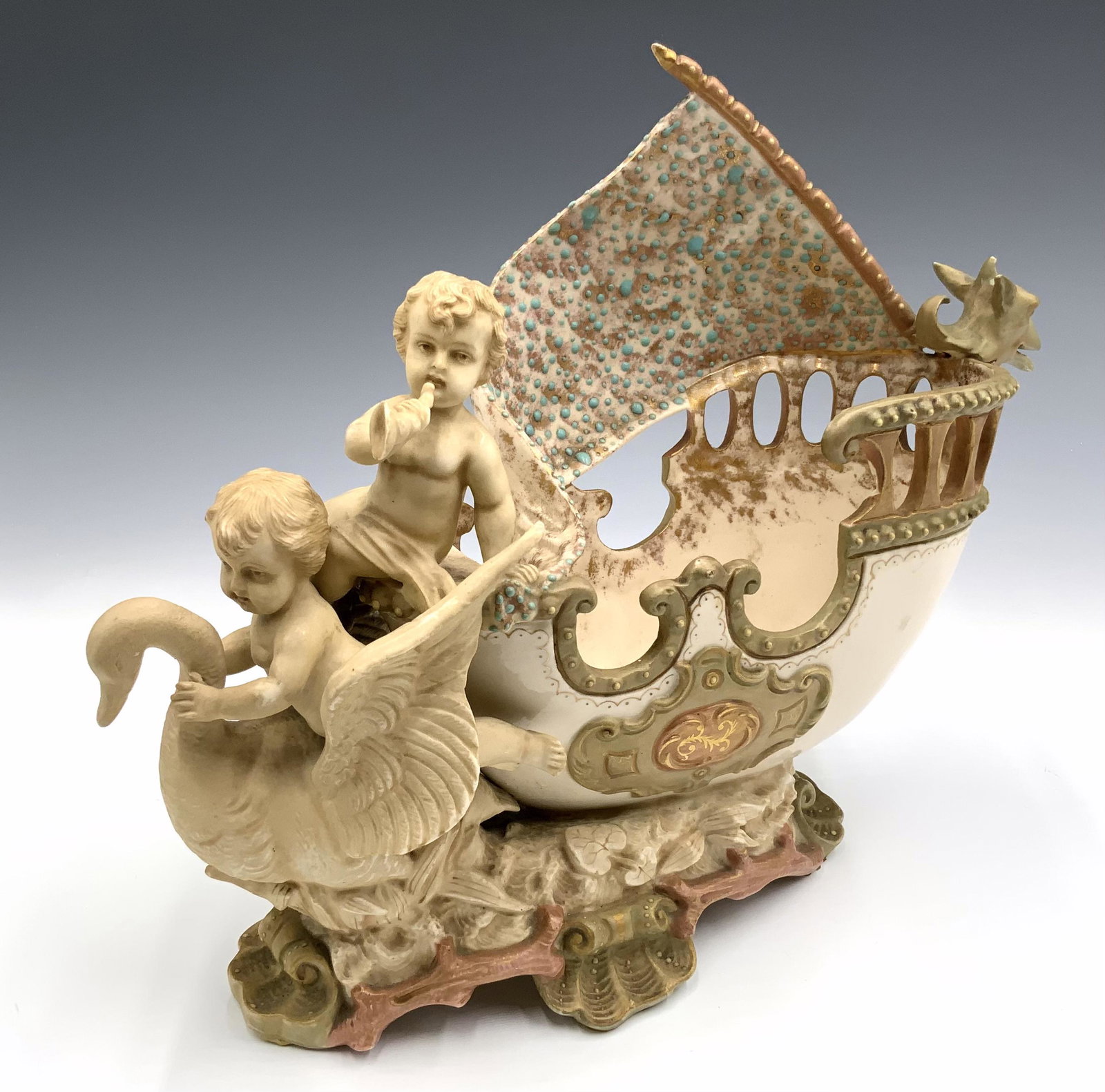 Royal Rudolstadt Figural Porcelain Piece.: Antique, with Goose and Cherubs. Marked RW on the Bottom. In Very Good Condition. Measures 9 1/2" Tall by 12" Wide. Third-Party Shipping or Personal Pickup Required.