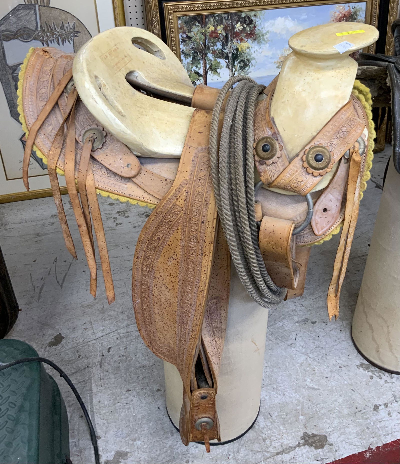 Tan-Colored Leather Western Saddle.: With Intricate Hand-Tooled Leather. Stamped "La Gitana - Luis Jimenez e Hijos". Measures 24" Long and 16 1/2" Wide. Third-Party Shipping or Personal Pickup Required.