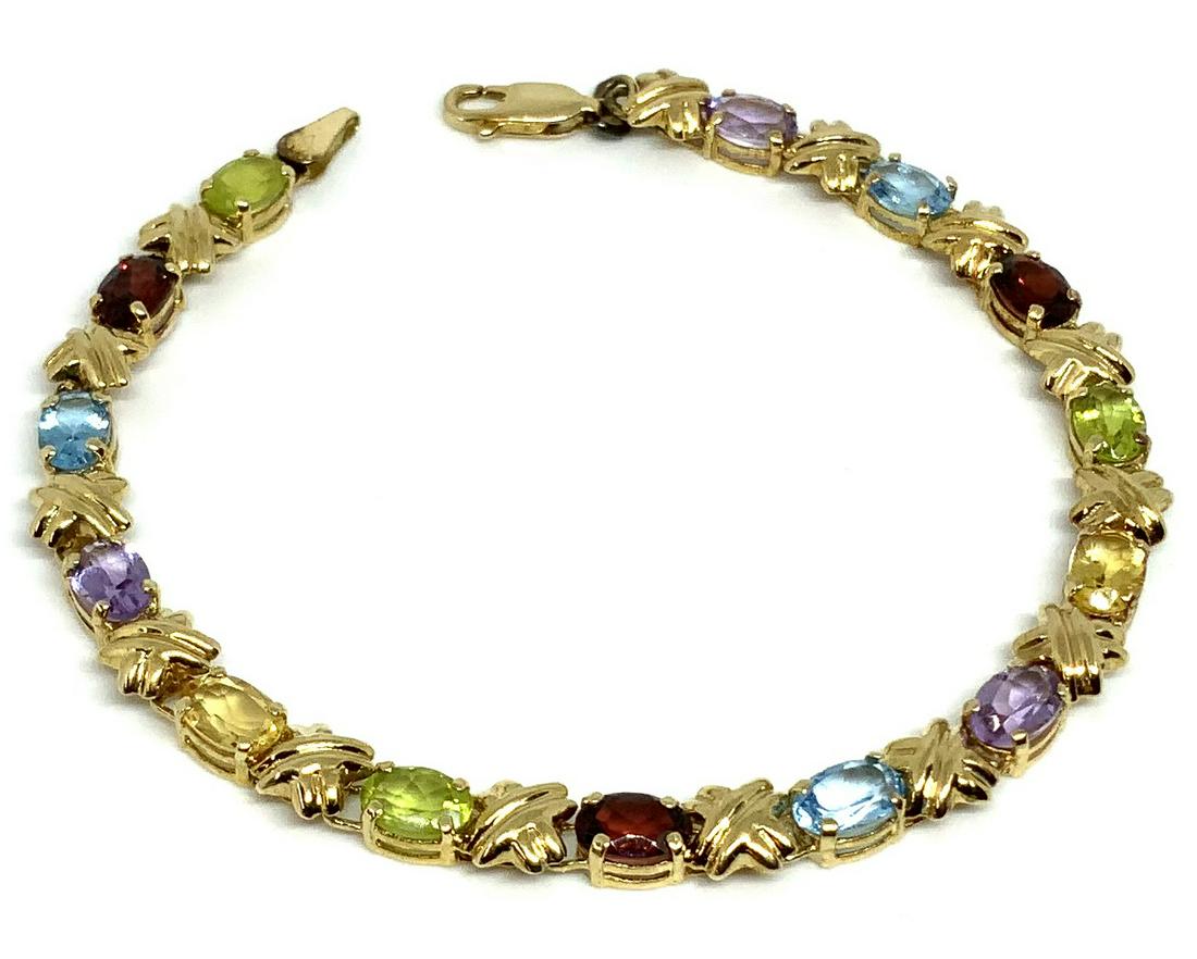 14K Gemstone Ladies' Bracelet.: With Garnet, Blue Topaz, Peridot, Citrine, and Amethyst. Measures 7" Long and 3/16" Wide.