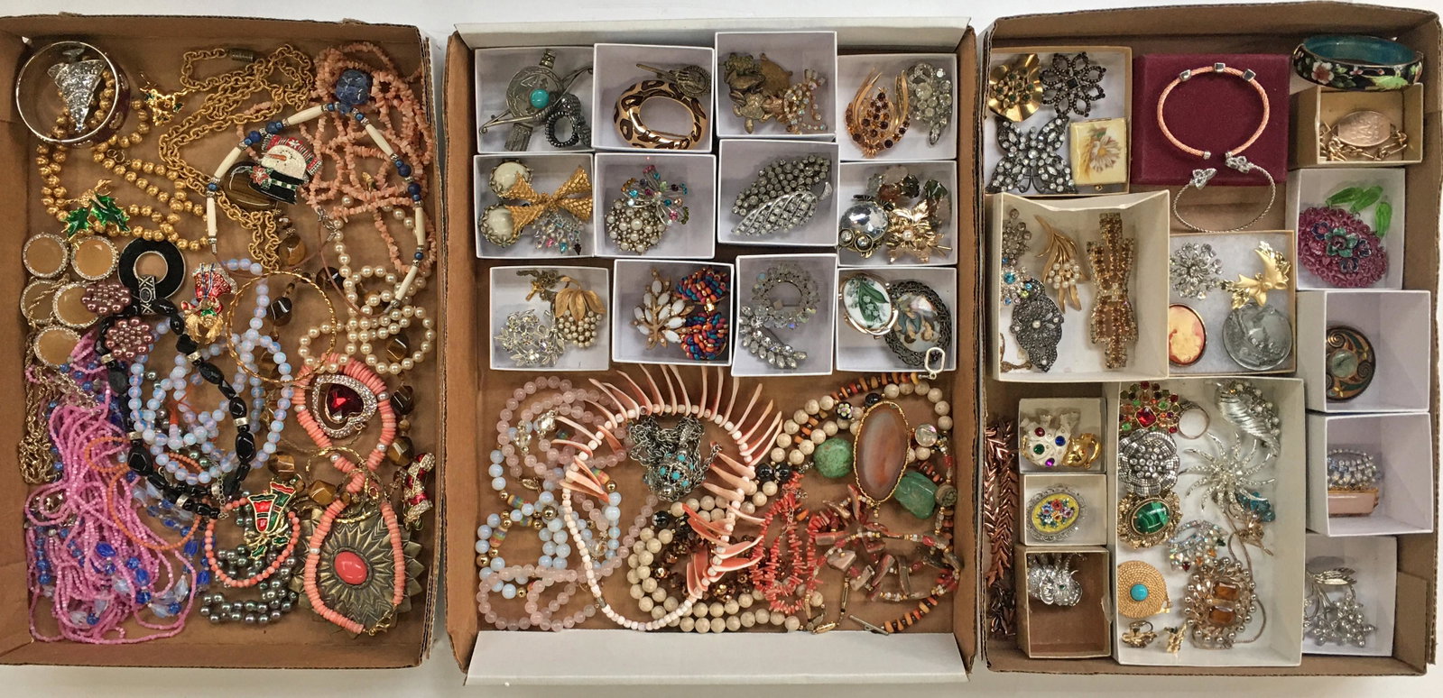 Lot: 3 Trays of Costume Jewelry.: Includes Christmas items, rhinestone pieces, some coral. Third-Party Shipping or Personal Pickup Required.