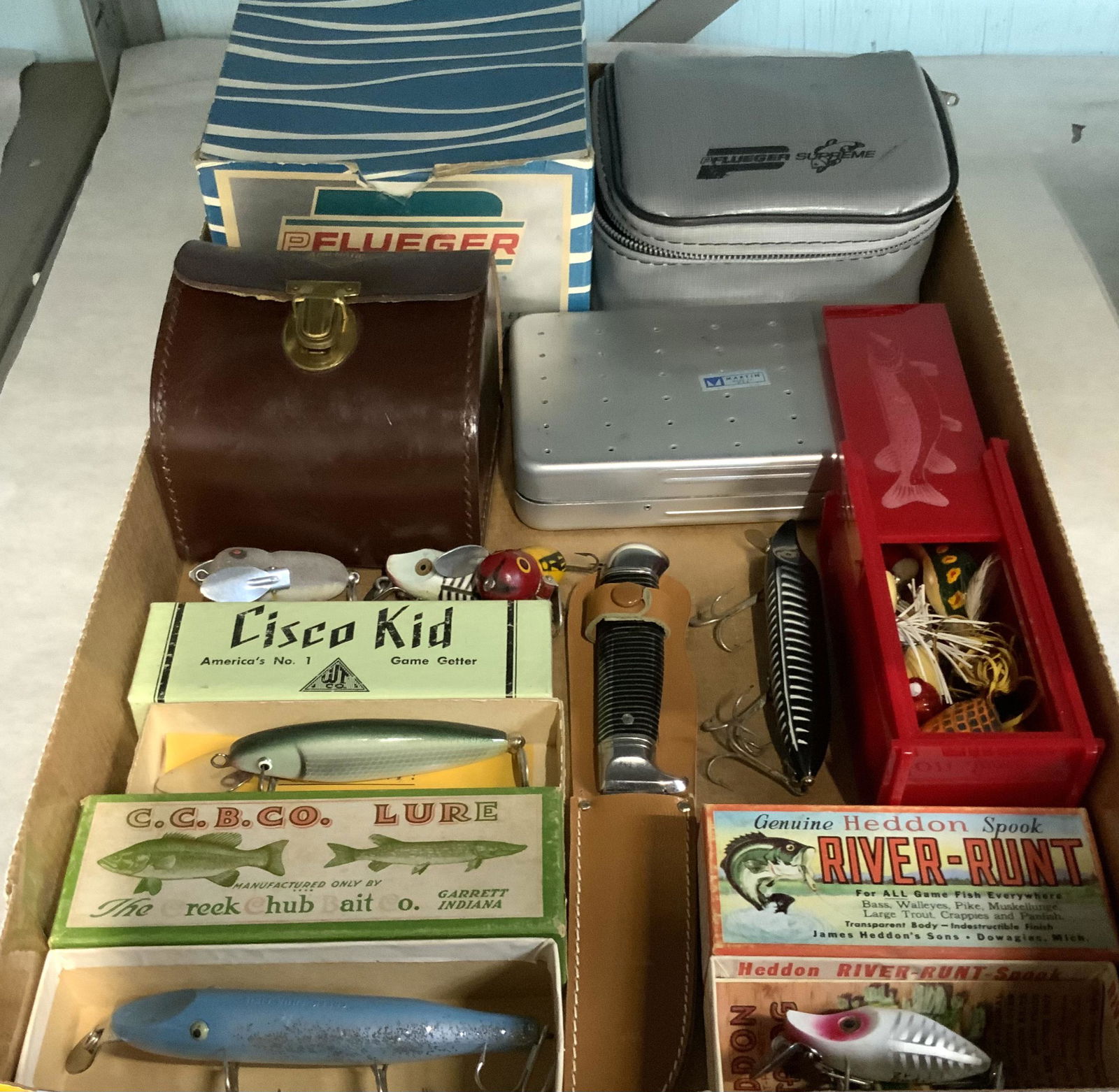 Lot of Vintage Fishing Lures & Fishing Equipment.: Also, Fishing Flies. Includes: Cisco Kid, Heddon Spook River-Runt, a Pflueger 510 Supreme Reel, a Leather Case, a Knife, etc. - Third-Party Shipping or Personal Pickup Required.