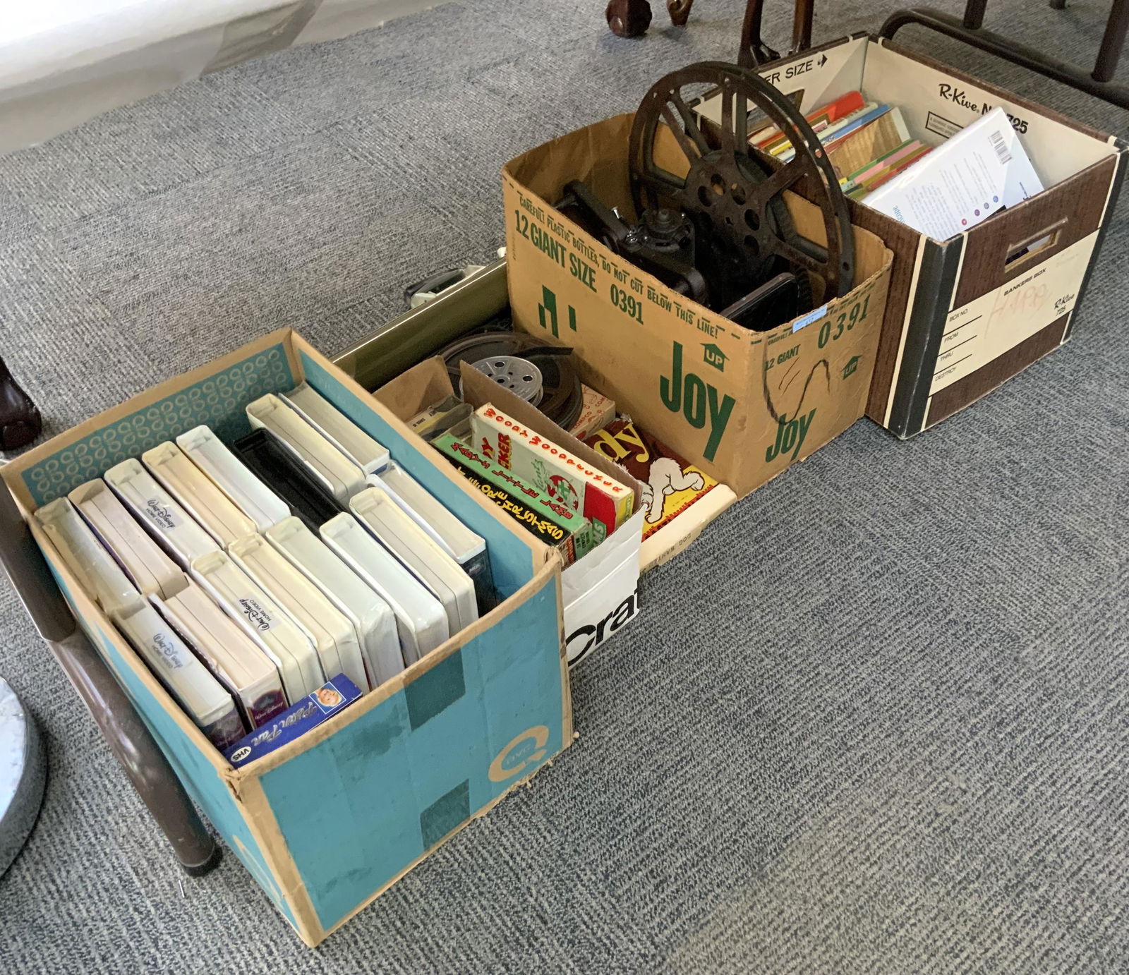 Large Lot of Vintage Films, Videotapes, etc.: Also, Peanuts Books. Also Includes a Projector. The Videotapes are Disney Cartoons, some still Sealed. The Films are Puddy the Pup and Others. There are 7 Unopened Disney Tapes - Lady & the Tramp, Cin