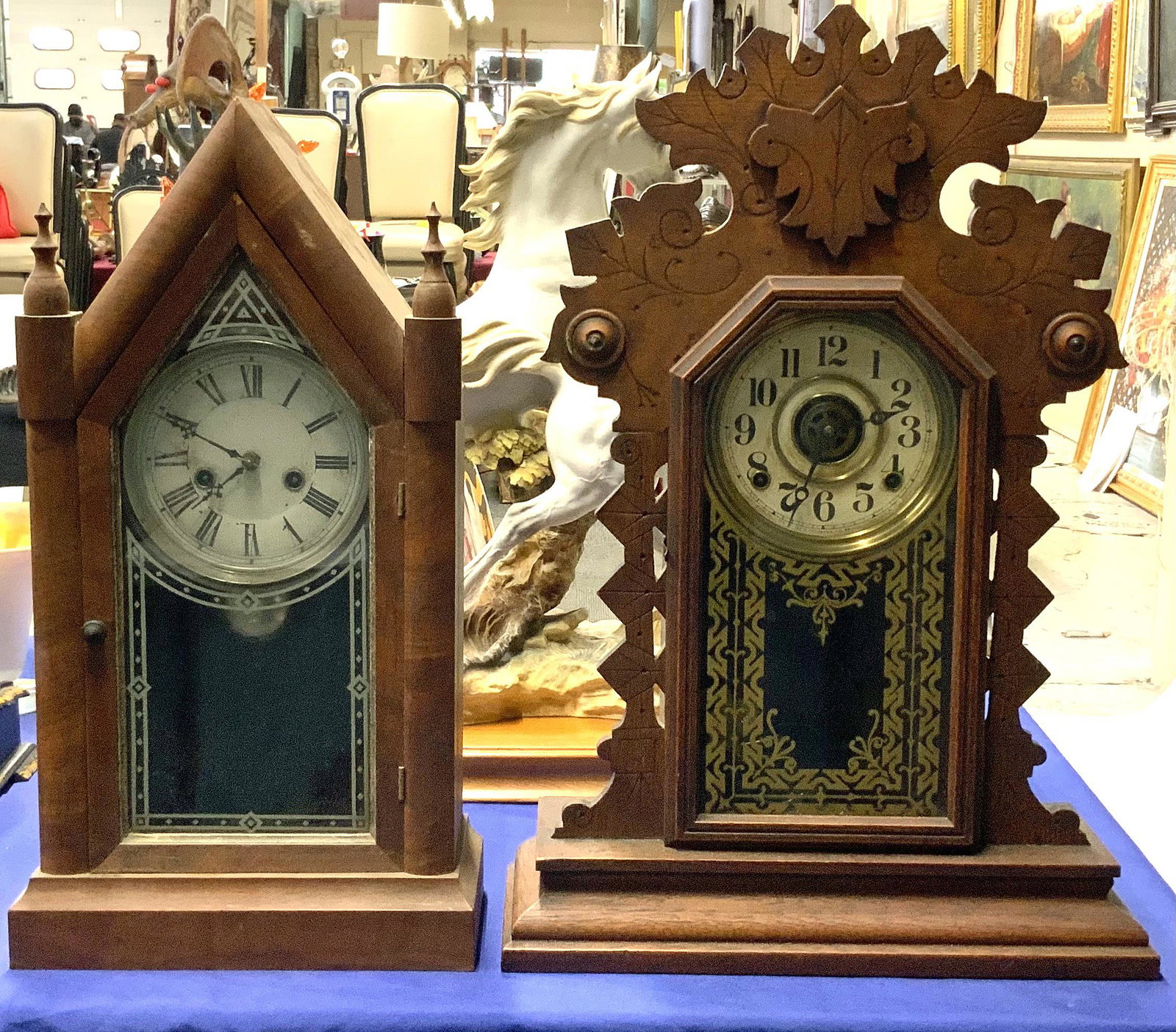 Lot of 2 Carved Wood Clocks: Gingerbread & Gothic.: 23" and 20.5" tall, respectively. Working condition unknown. Third-Party Shipping or Personal Pickup Required.