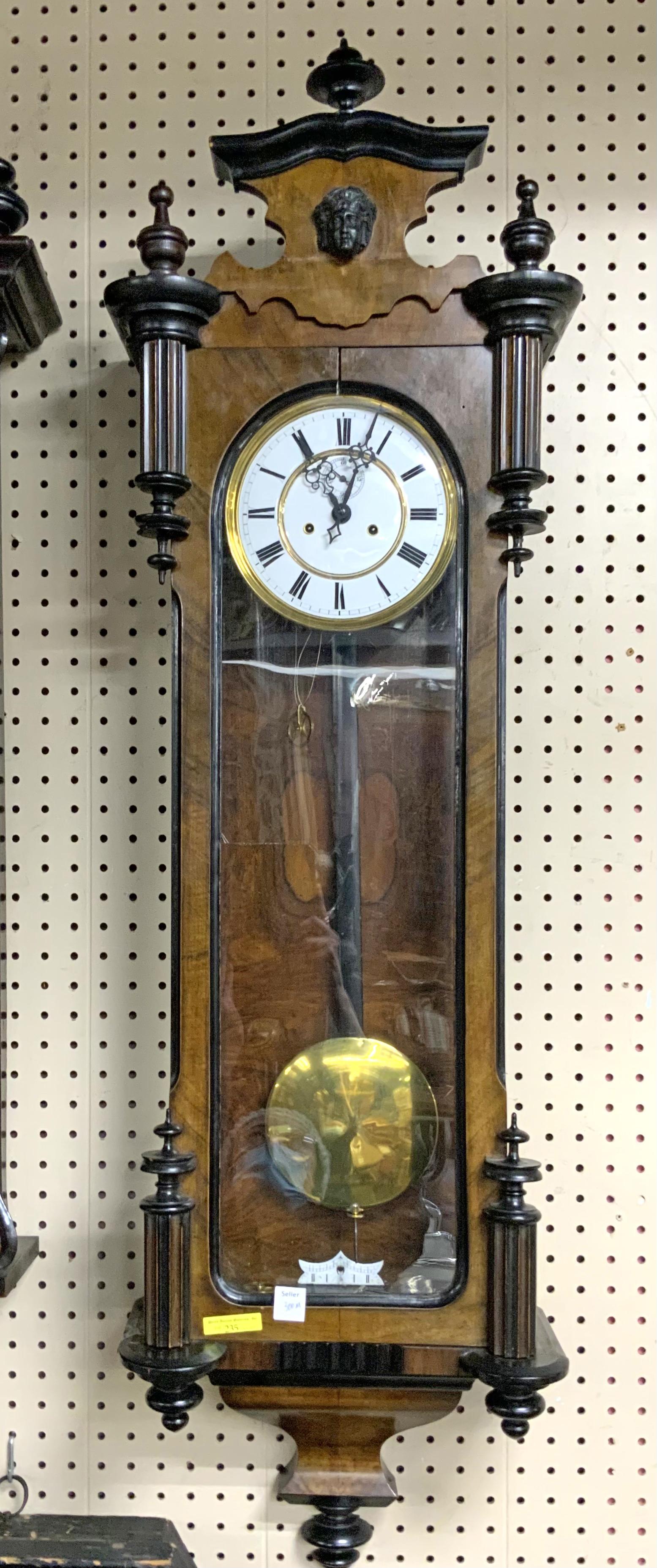 Wood Regulator Wall Clock w/ Man's Face.: Working condition unknown. Measures 45.25" tall, 13" wide x 6.5" deep. There are a few scratches and splits in the wood. Third-Party Shipping or Personal Pickup Required.