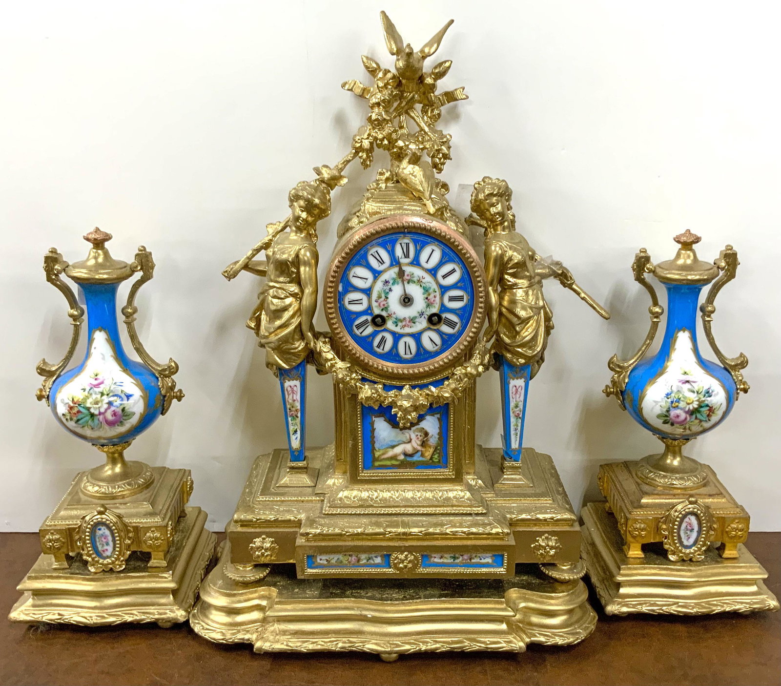 French-Style Gold Gilt Garniture Clock Set.: Clock is 17.5" tall; working condition is unknown. The three bases are not attached, and look to be gold painted plaster. The lids of the vases are attached. Third-Party Shipping or Personal Pickup Re