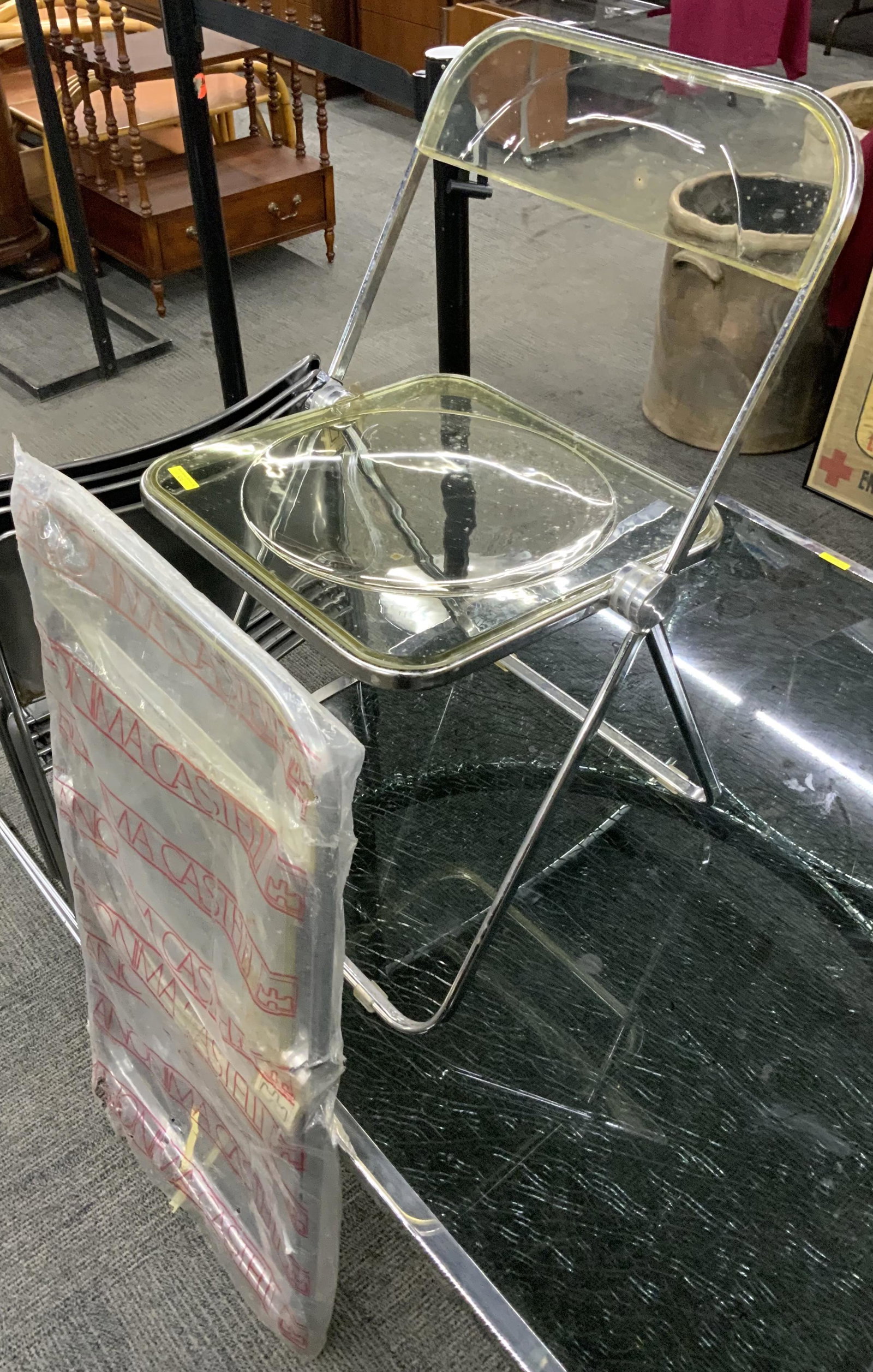 Pair of Castelli Lucite & Metal Folding Chairs.: With the Original Plastic Slipcovers, and Original Tags. Unfortunately, these Weren't Kept Well, and they have Mold Spots on Them. Hopefully, they can Still be Cleaned. Third-Party Freight Shipping or