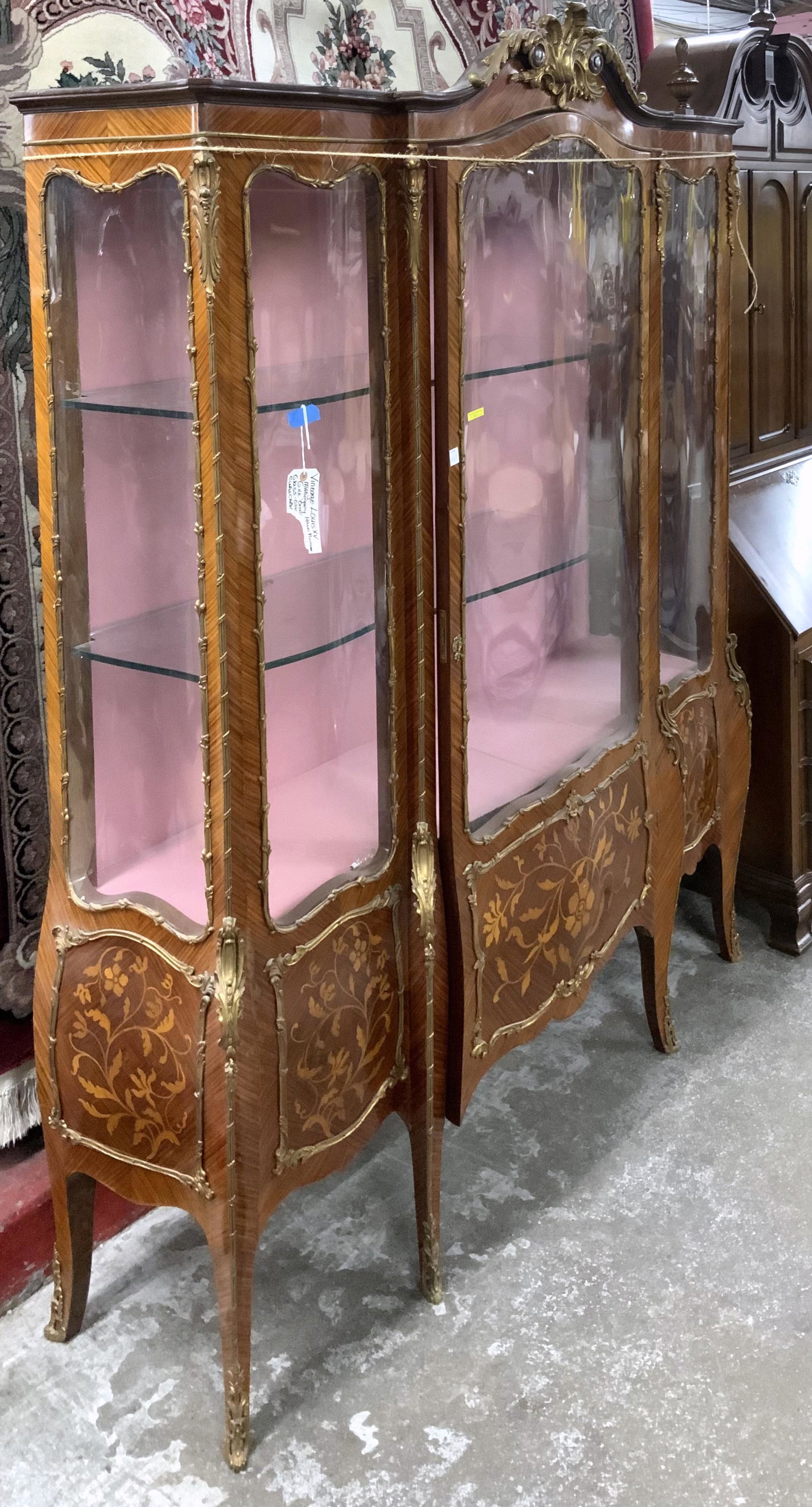French-Style Inlaid Breakfront w/Ormulu.: The Ormulu is Either Brass or Bronze. Looks like it is Missing some Shelving on the Right Hand Side. The French China Cabinet Measures 57" Wide, 81" High, and 16" Deep. Third-Party Freight Shipping or