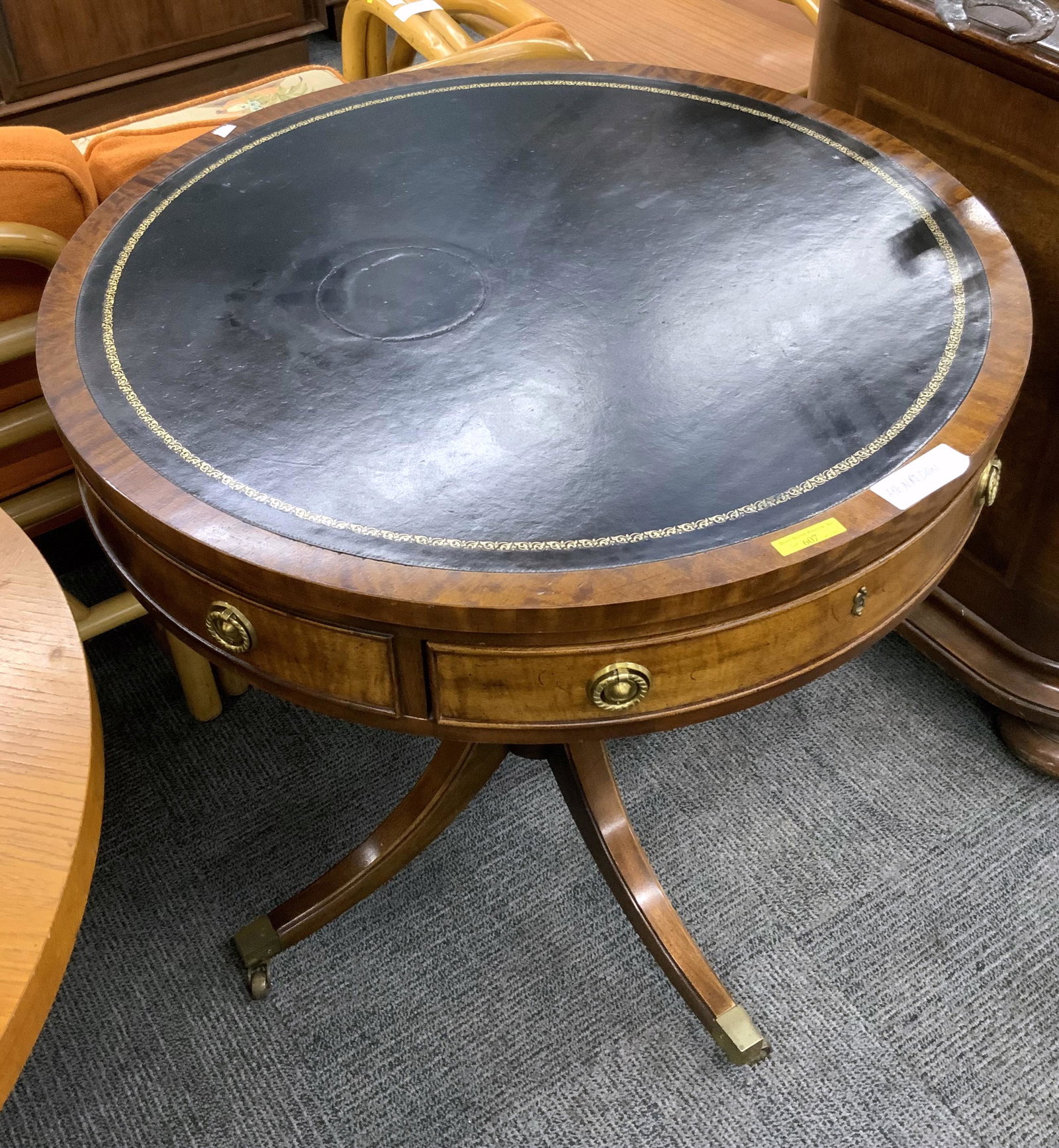Henredon Leather-Top Lamp Table, As Is.: With a Center Drawer. A 5" Diameter Indentation is on the Top. Also, it is Missing a Small Strip of Wood on the Side. Measures 28" in Diameter. Third-Party Freight Shipping or Personal Pickup Required