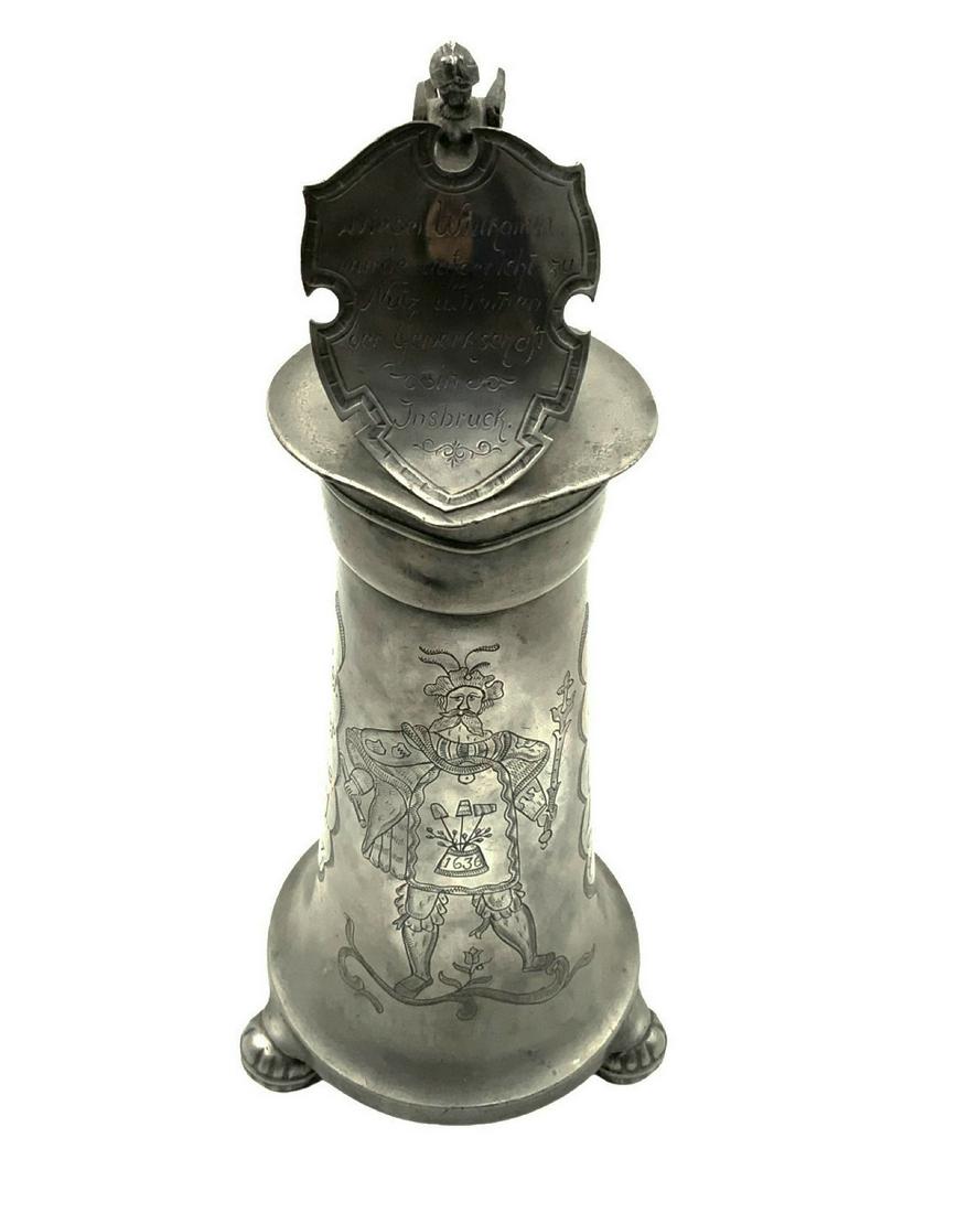 Medieval Pewter Flagon Tankard w/Nobleman Design.: With a Date of 1636 on the Chest of the Nobleman. With a Shield Design on the Lid, Inscribed in German. Also with an Angel / Serpent Woman Figural Finial on the Lid. Maker Marks are on the Handle. Mea