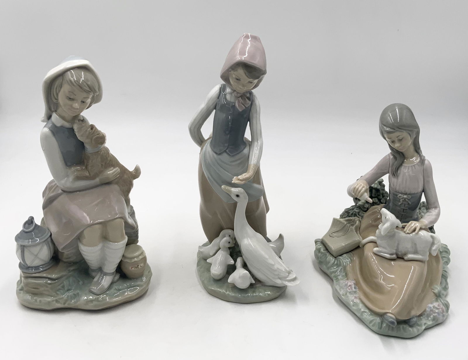 Lot of 3 Lladro Girl Figurines w/ Animals.: #4982, "Naughty Dog"; #1312, "Little Bo Peep"; and, "Girl Feeding Goose & Goslings". Nice condition, with no damage noted. The tallest is 9.5" tall. Third-Party Shipping or Personal Pickup Required.