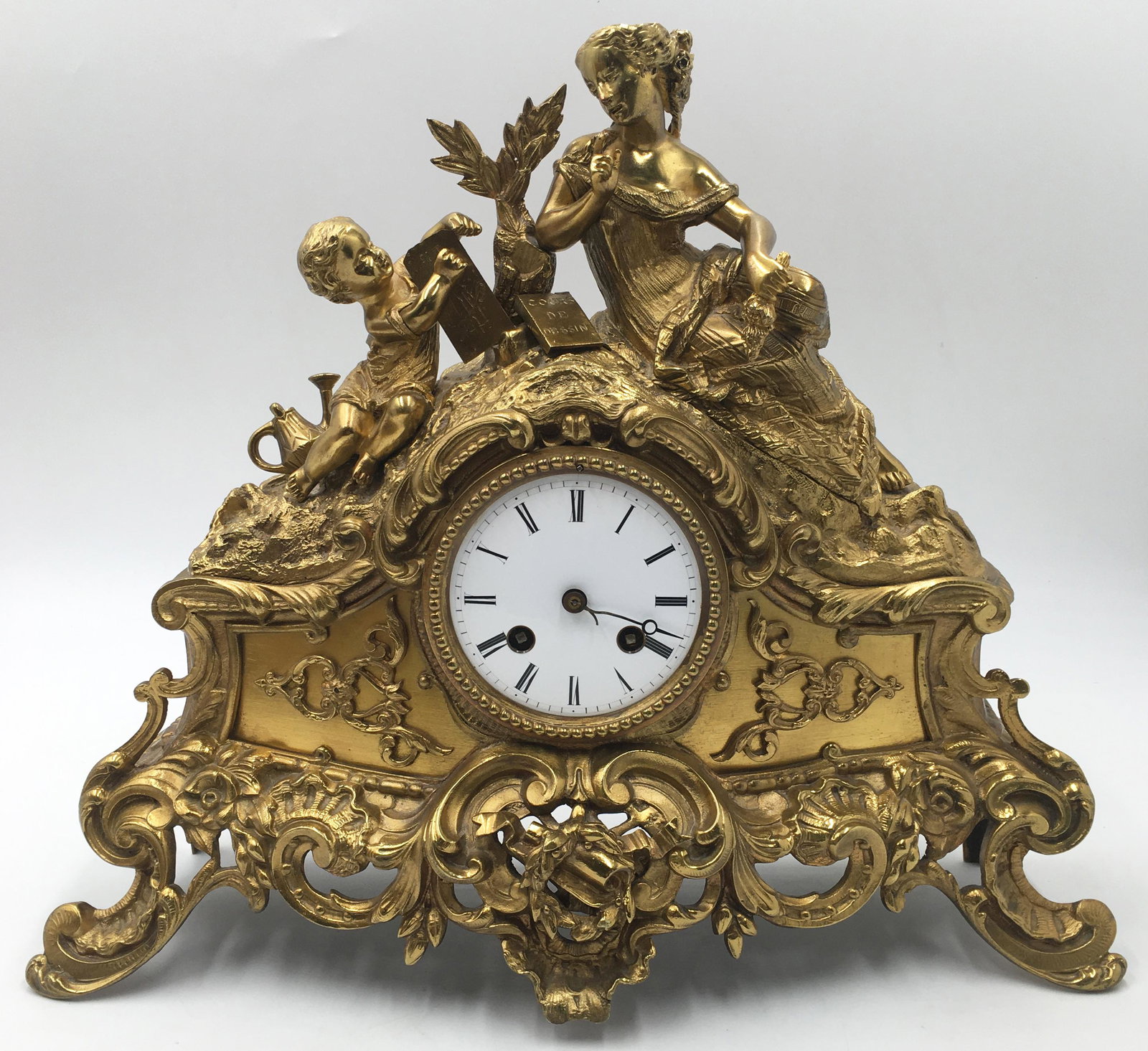 Heavy Figural Mantel Clock w/ Gold Colored Finish.: The clock is missing some mechanical parts. Cosmetically, it is in nice shape. 13.5" tall, 15.5" long, 5" wide. Third-Party Shipping or Personal Pickup Required.