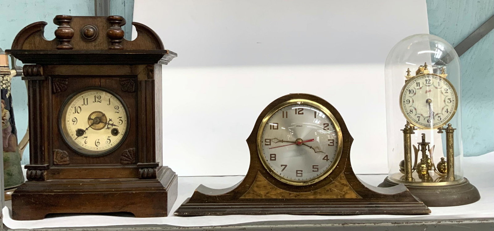 Lot of 3 Vintage Mantel Clocks.: The tallest is 13", and appears to be unmarked. The two shorter clocks are marked "Gilbert" and "Schatz". Working condition unknown. Third-Party Shipping or Personal Pickup Required.