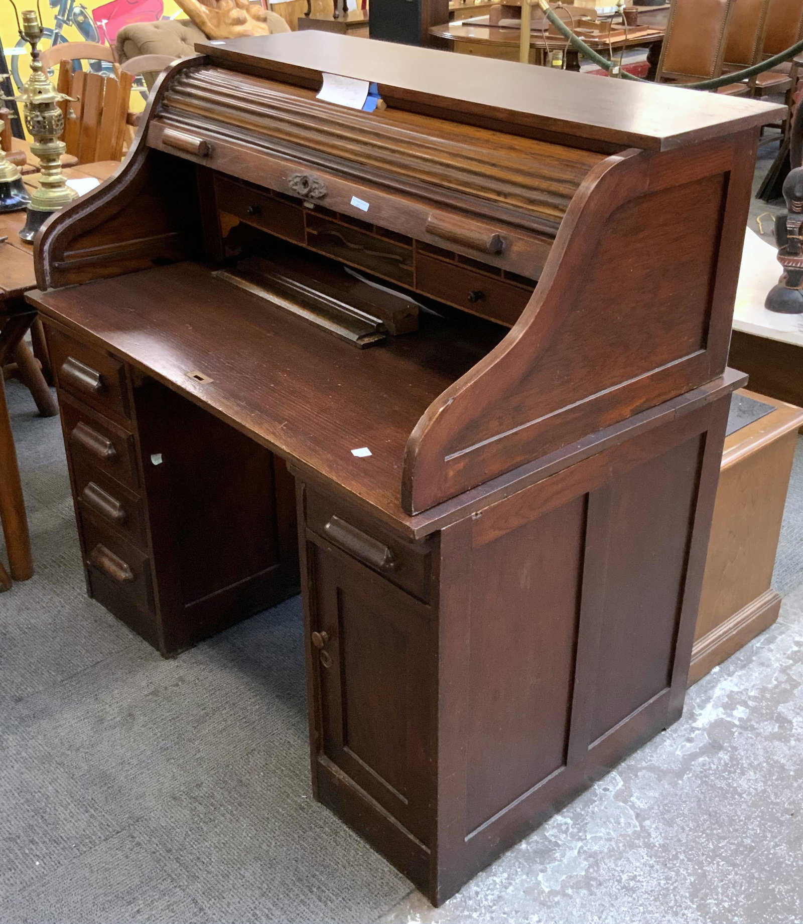 Dark Stained Ship Captain's S-Type Rolltop Desk.: Mostly Oak. Antique. In Overall Good Condition, has some Scratches on the Writing Surface, and the Roll Top is Coming apart a Bit. Measures 48" Tall, 48" Wide, and 30" Deep. Third-Party Freight Shippi