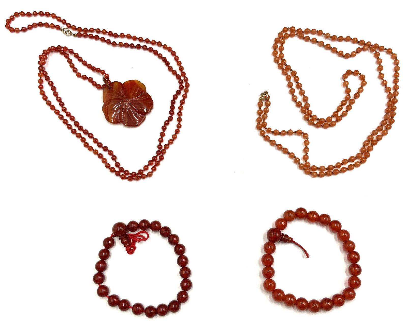 Lot of Carnelian Necklaces & Bracelets.: Includes a Beaded Carnelian Necklace with a Carved Flower Pendant (Pendant Measures 1 1/2" in Diameter, Necklace Measures 34 1/2" Long, Beads Measure 3mm in Diameter). Also, a Lighter Colored Beaded C
