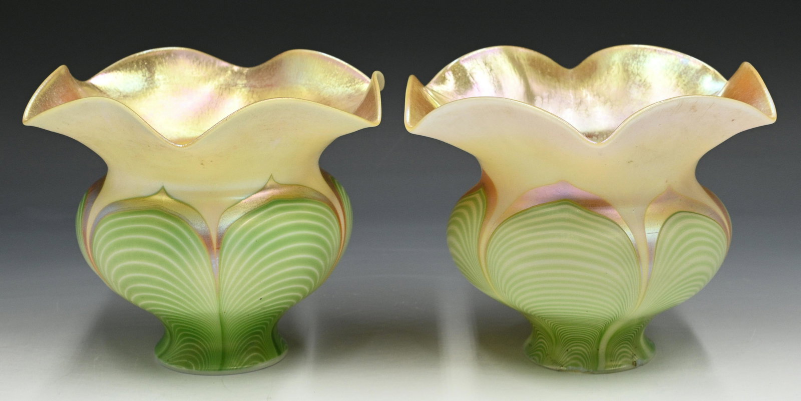 Pair of Iridescent Art Glass Lamp Shades.: Unsigned, in the style of Loetz or Quezal. 5.5" tall, 6" in diameter. One of them has several chips on the Stem, and a Crack in the Side (see Photo). Third-Party Shipping or Personal Pickup Required.