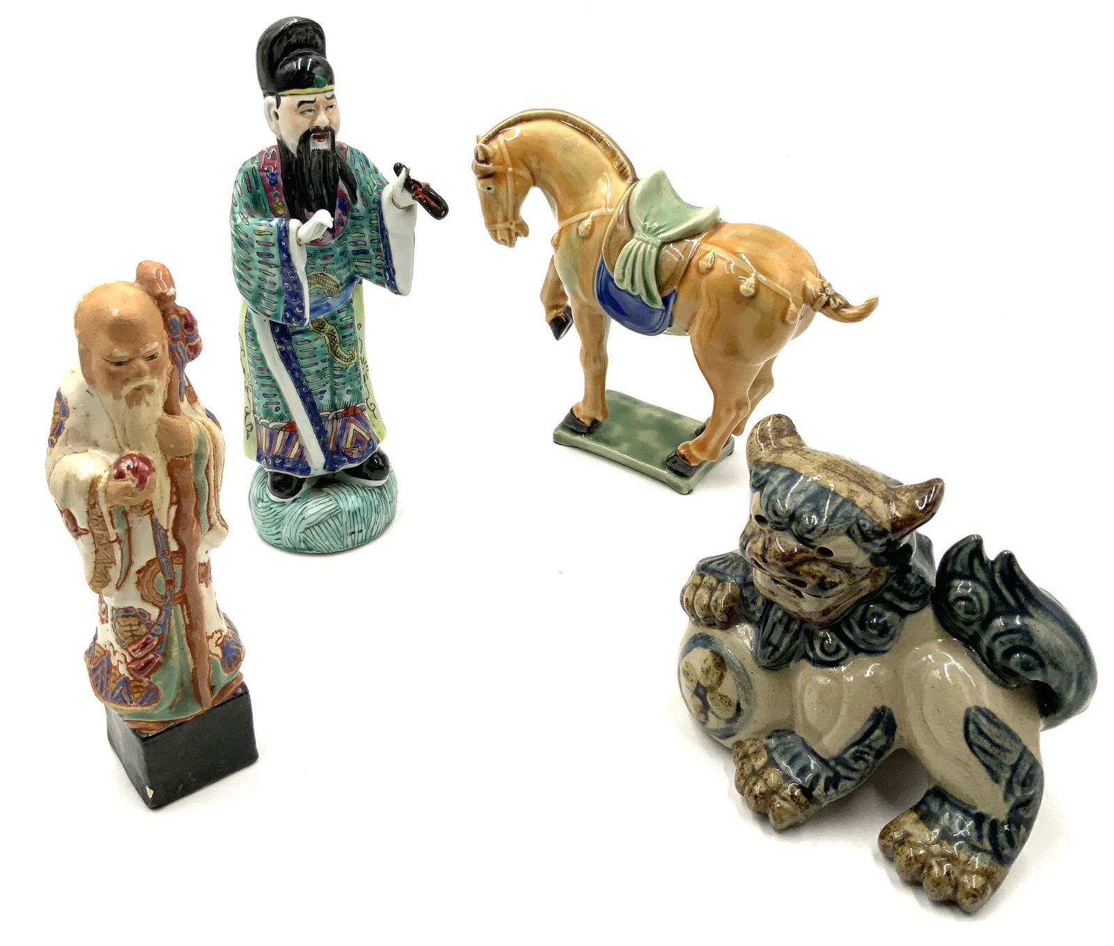Lot of 4 Asian Pottery / Porcelain Figurines.: Includes a Chinese Porcelain Man Figure (9" Tall), a Ceramic Foo Dog (5" Tall, 6" Wide), a Clay Asian Man Figure (7 1/2" Tall), and a High-Glaze Ceramic Horse (6 3/4" Tall, 8" Wide). Third-Party Shipp