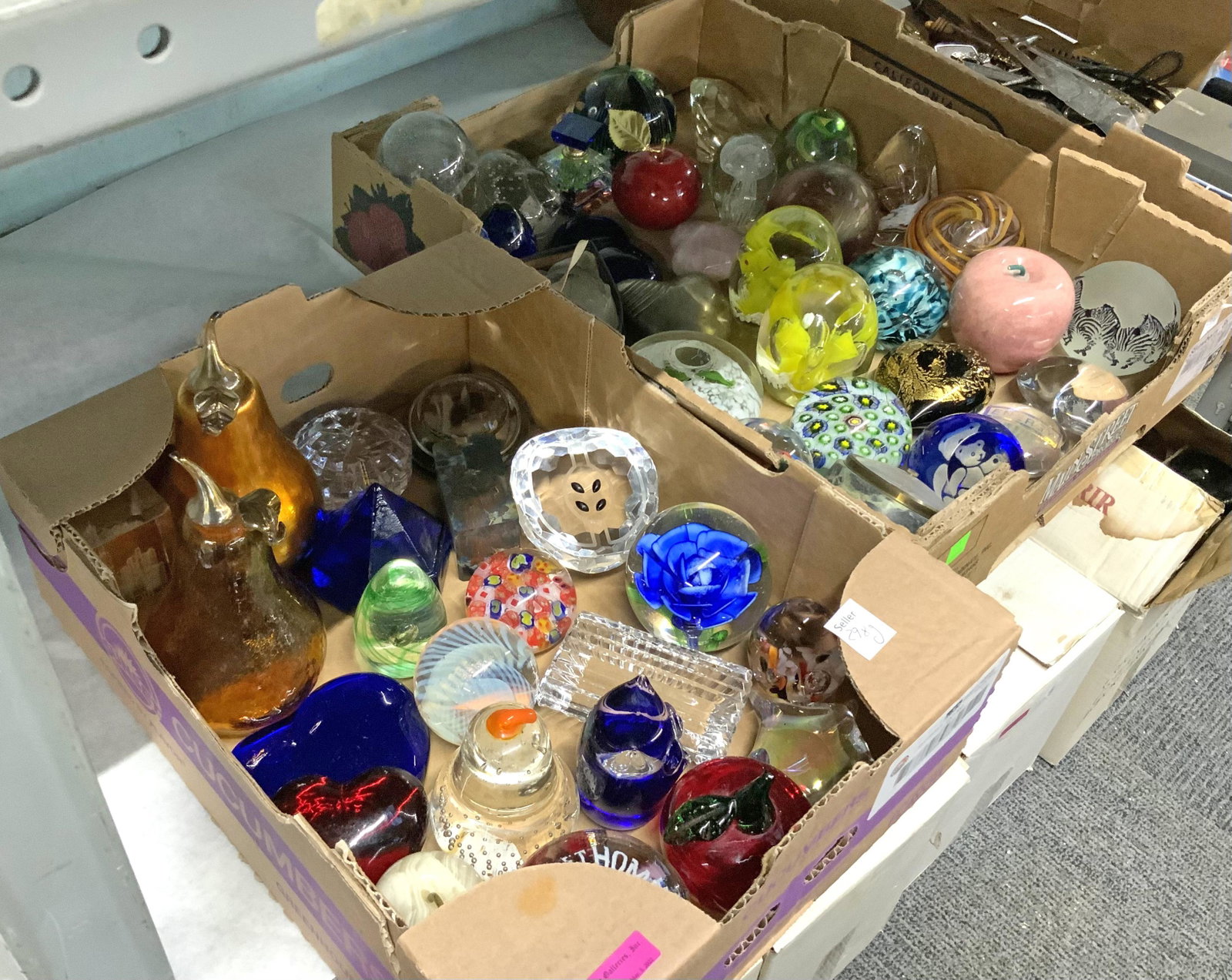 2 Boxes of Assorted Paperweights.: Most are unmarked, but there are Rosenthal, Baccarat, and Eickholt pieces in this lot. Third-Party Shipping or Personal Pickup Required.
