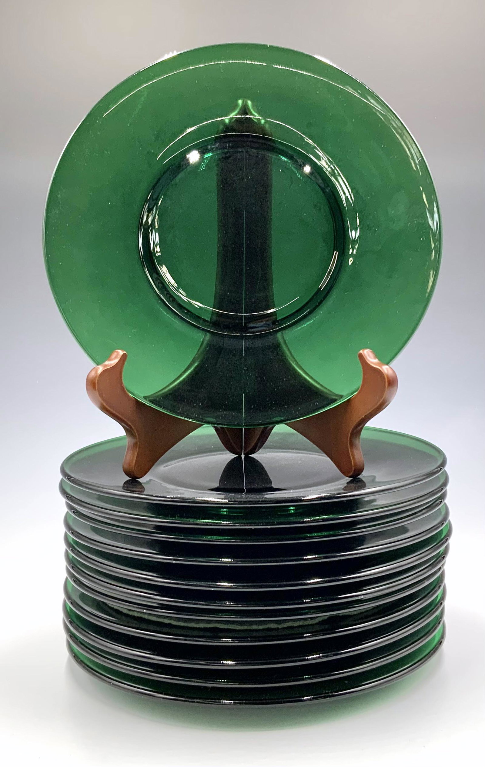 Set of 12 Emerald Green Glass Salad Plates.: 8.25" in diameter. They have some scratches, but look to be in good condition. The soft dividers between them are marked, "Tiffany" but the plates themselves are unmarked. Third-Party Shipping or Pers