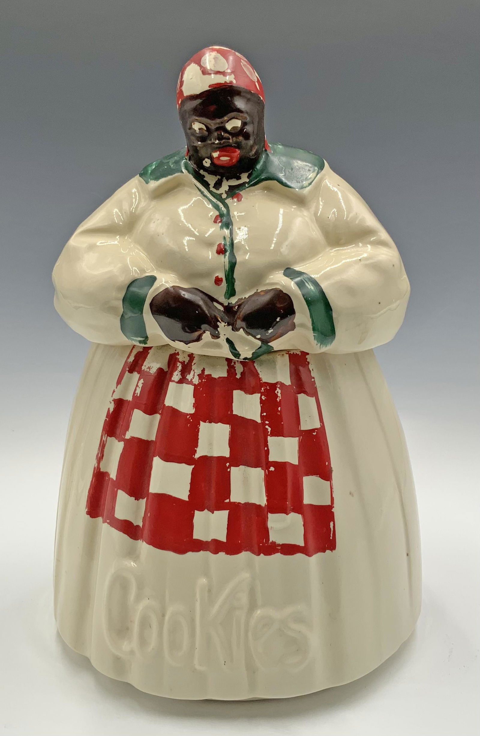 McCoy Pottery "Mammy" Black Americana Cookie Jar.: She is 11" tall. McCoy mark is on the underside. There is some crazing present. The only areas with chips/cracks are on the interior and bottom of the lid. They are not visible when the lid is on. Thi