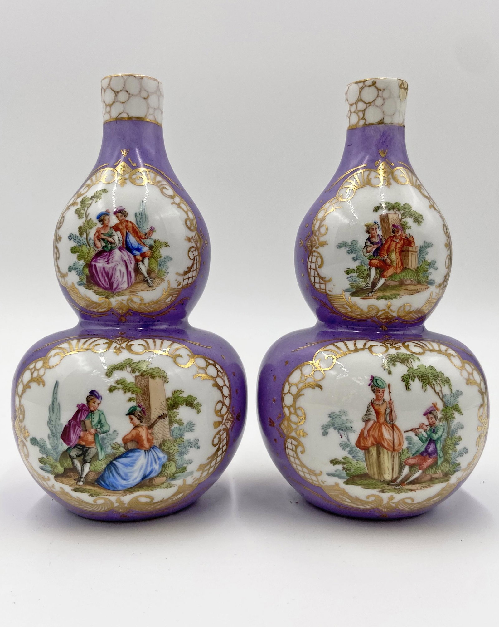 Pair of Meissen Augustus Rex Double Gourd Vases.: Each measures 7" tall, and are not very heavy. They have multiple courting scenes on both the front and back. Both bear the "AR" monogram on the underside. One of them has a repair on the rim. Third-P