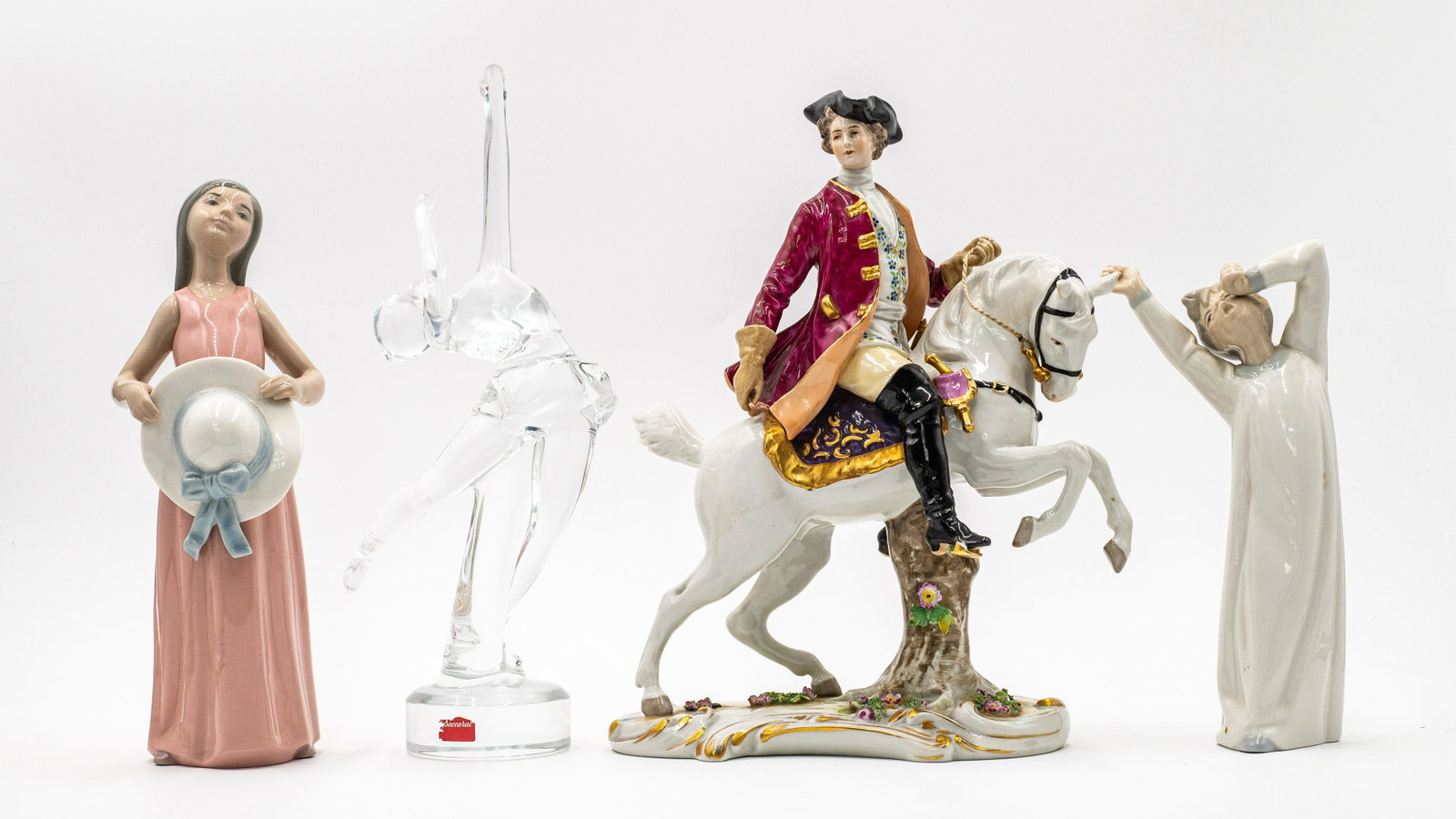 Lot of Figurines: Lladro, Baccarat, Volkstedt.: The Baccarat figurine is an ice skater, the Lladros are a boy and girl, and the Volkstedt is a man on a horse. They are in Good condition overall; the Volkstedt figure has a broken stirrup. It is the 