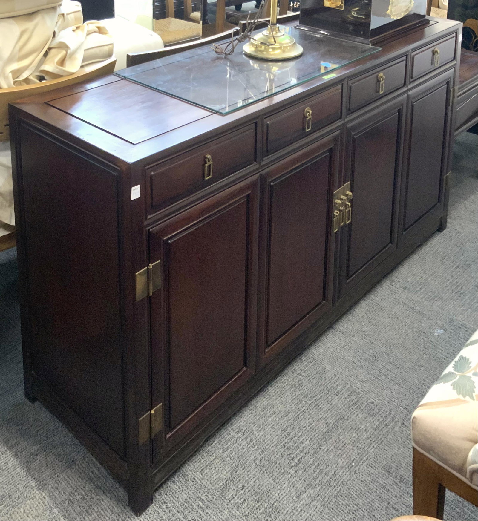 Asian-Style 4-Door Mahogany Sideboard.: With Asian-style detailing and brass hardware work. There are 4 drawers and 4 doors, with a shelf behind the doors for storage. The Piece Measures 60" wide, 18" deep, and 32" tall. Third party Freight