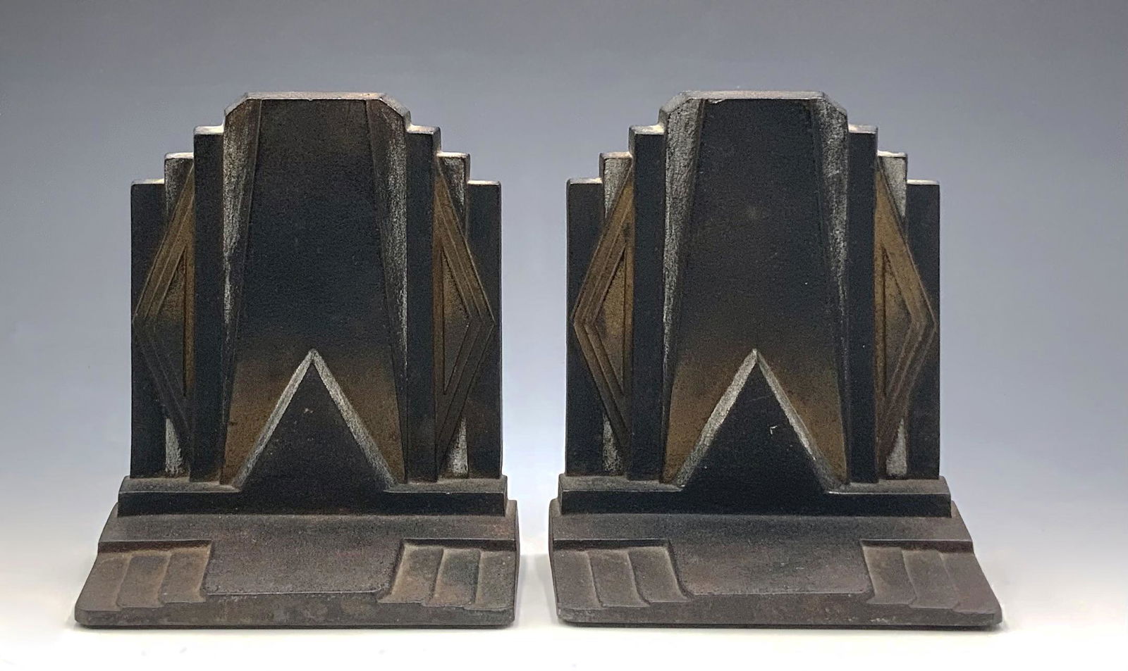 Pr Bradley & Hubbard Art Deco Cast Iron Bookends: Modeled after the Ziggurat Skyscrapers of the time, these are Cold-painted with bronze-like gold and silver accents. Each bookend measures 5 3/4" tall, 5 1/2" wide, and 2 1/2" deep. They are in Nice c