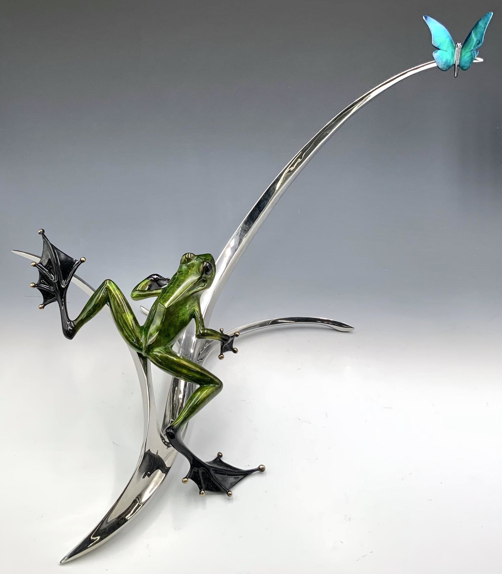 Tim Cotterill Large Bronze Frog w/ Butterfly.: Signed and numbered 14/75. There is some enamel loss along the edges of the butterfly's upper wings. There is also a small opaque blemish on the frog's right leg. The entire piece measures 14 1/2" tal