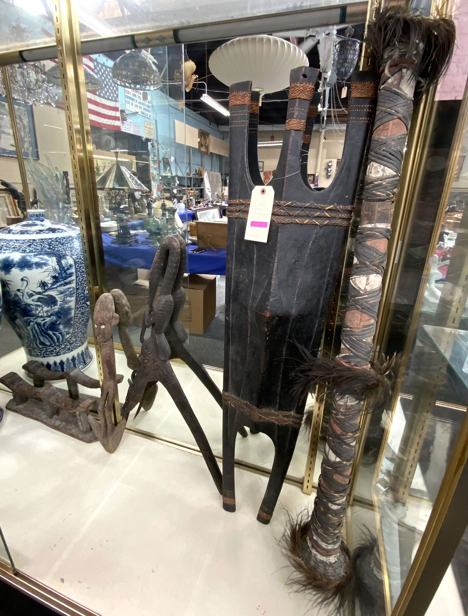 Lot: 5 Sepik River Papua New Guinea Tribal Items.: Includes sculptures, a feather-decorated hollow staff, a shield, etc. The longest item measures 48" tall. Third-Party Shipping or Personal Pickup Required.