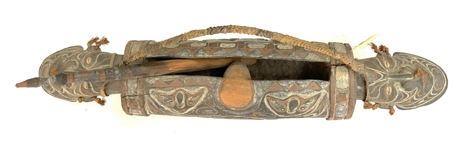 Sepik River Papua New Guinea Figural Drum.: With a woven carrying handle and a wooden playing Stick. The drum is carved, with a mask-like face on either end. The body of the drum also has several faces painted on it. It Looks to be in overall G