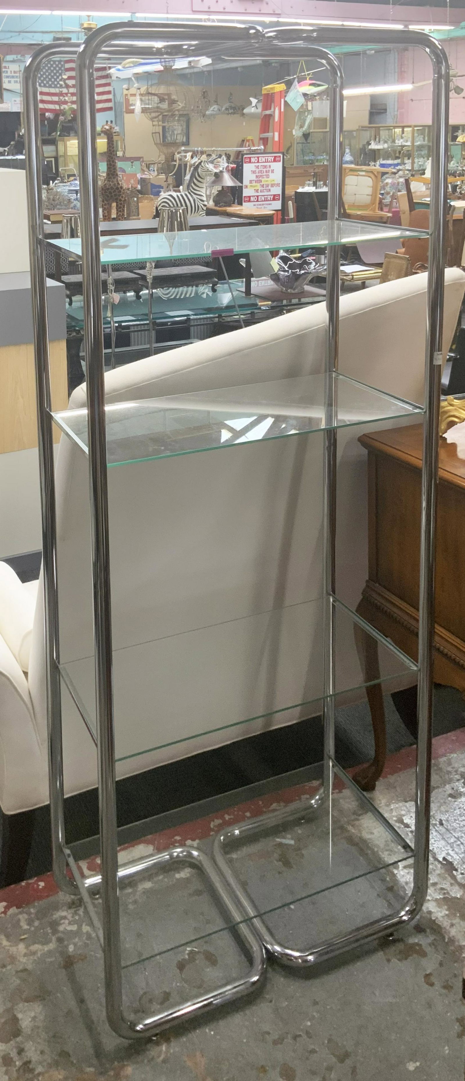 Moderne-Style Chrome and Glass 4-Shelf Bookcase.: A Bent chrome pipe design with removable shelves. There are No signs of damage - it is in good, useable condition. The Bookcase Measures 29" wide, 15 1/2" deep, and 74 1/2" tall. Third Party Shipping 