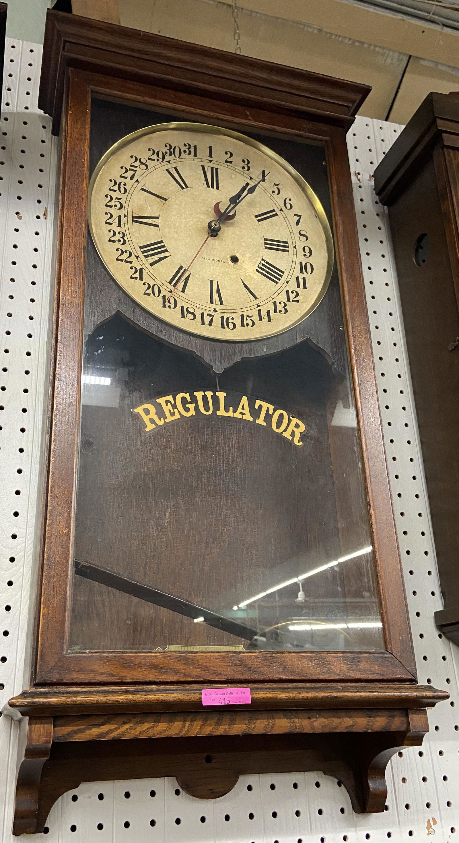 Antique Seth Thomas Regulator Calender Wall Clock.: This clock is mounted in a dark oak case and has a time only movement. There are no chimes. The clock appears to be in original condition and is unrestored, but intact. It Measures 16" wide, 6" deep,