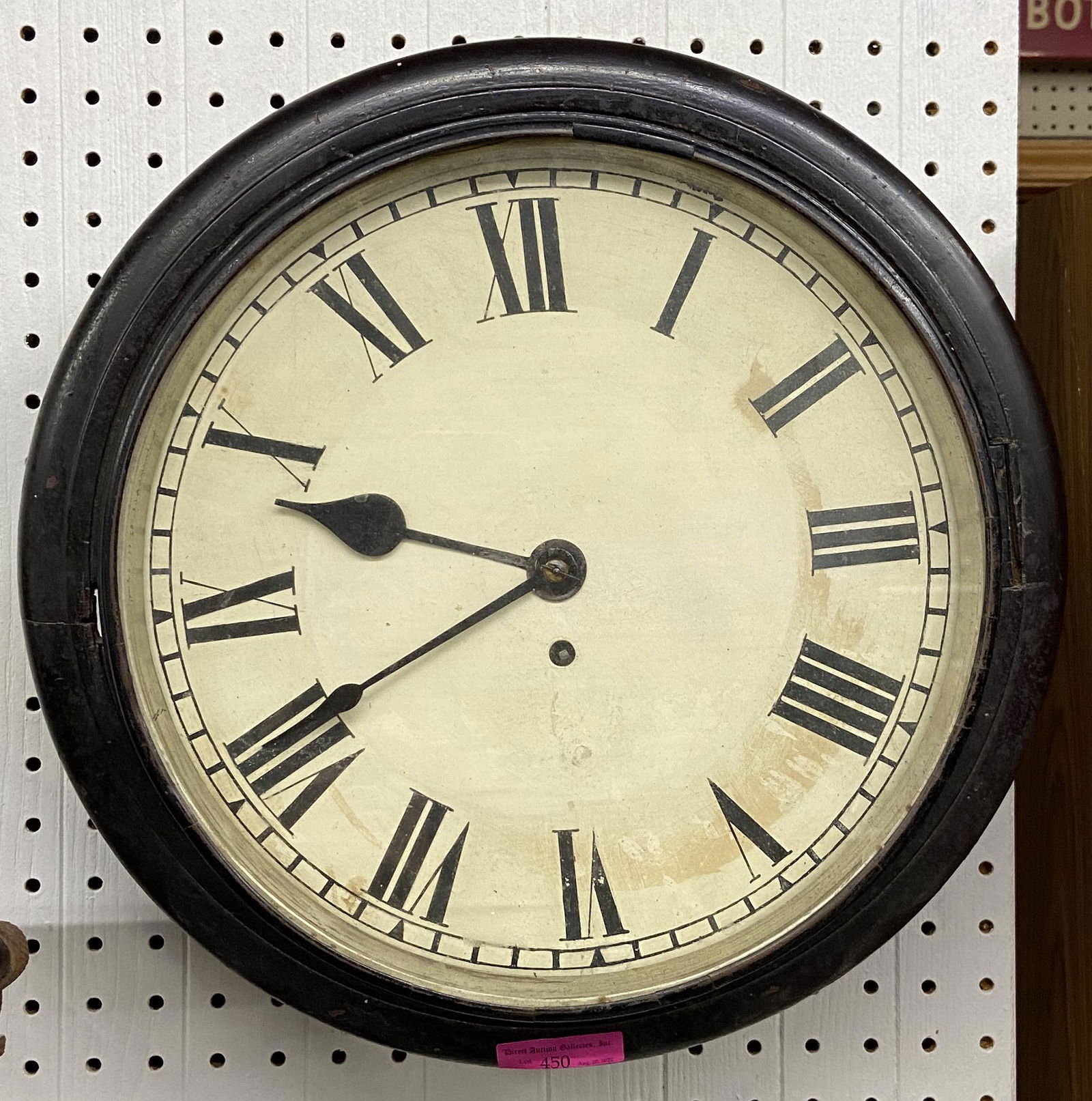 Round Antique Wall Clock.: The Bottom of the Clock has a Door which Flips open, where the Pendulum is Housed. Working Condition of the Clock is not Known. It measures 14 1/2" in Diameter. It looks like there is a Fastening Piec