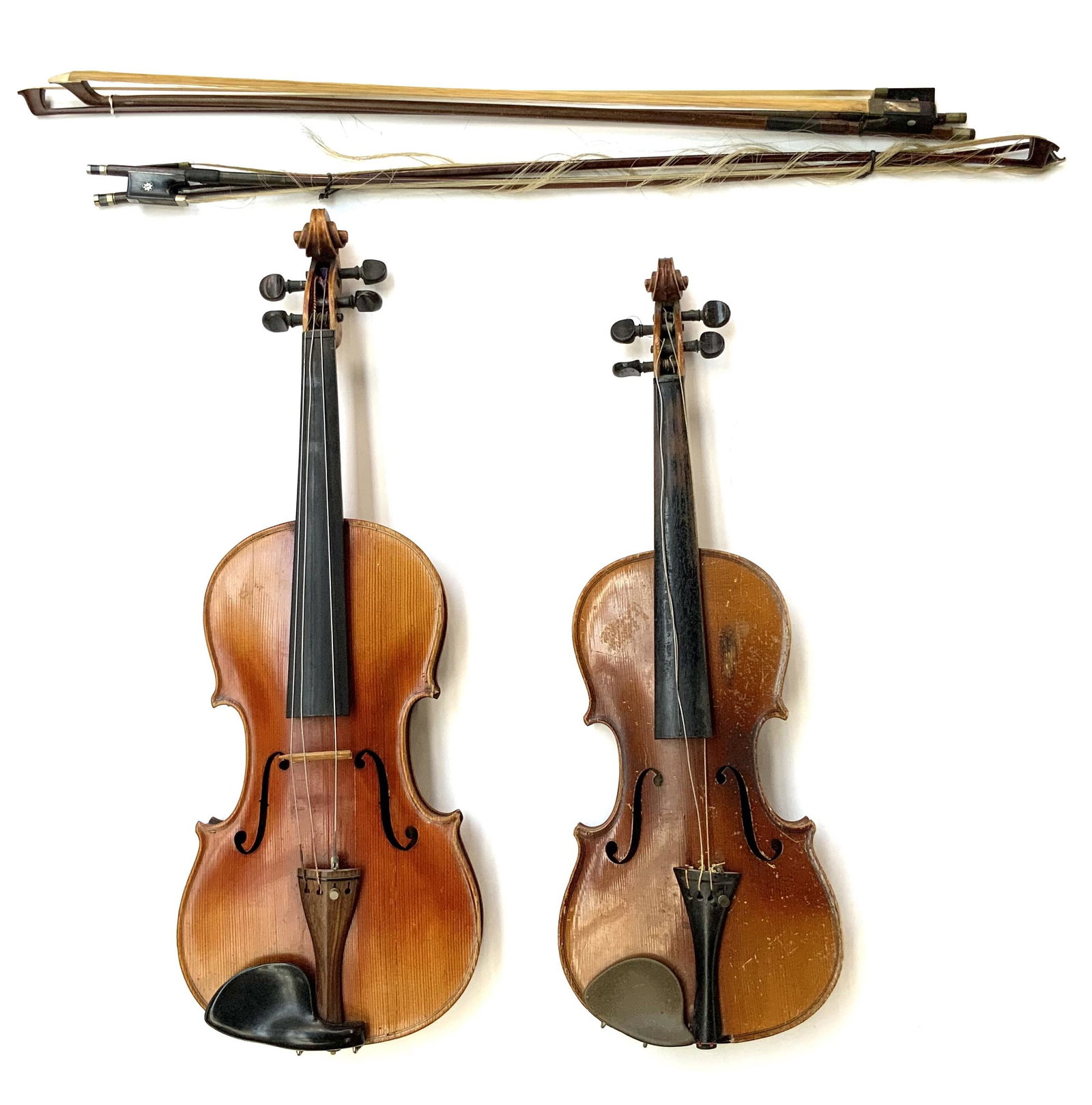 Lot of 2 Older Violins w/ 4 Bows.: One violin is marked as a Stradivarius copy. The other reads, "Nicolaus Amatus fecit in Cremona 1654" (Likely a Copy as well). They need to be restrung, and both have Scuffs and Scratches, especially 