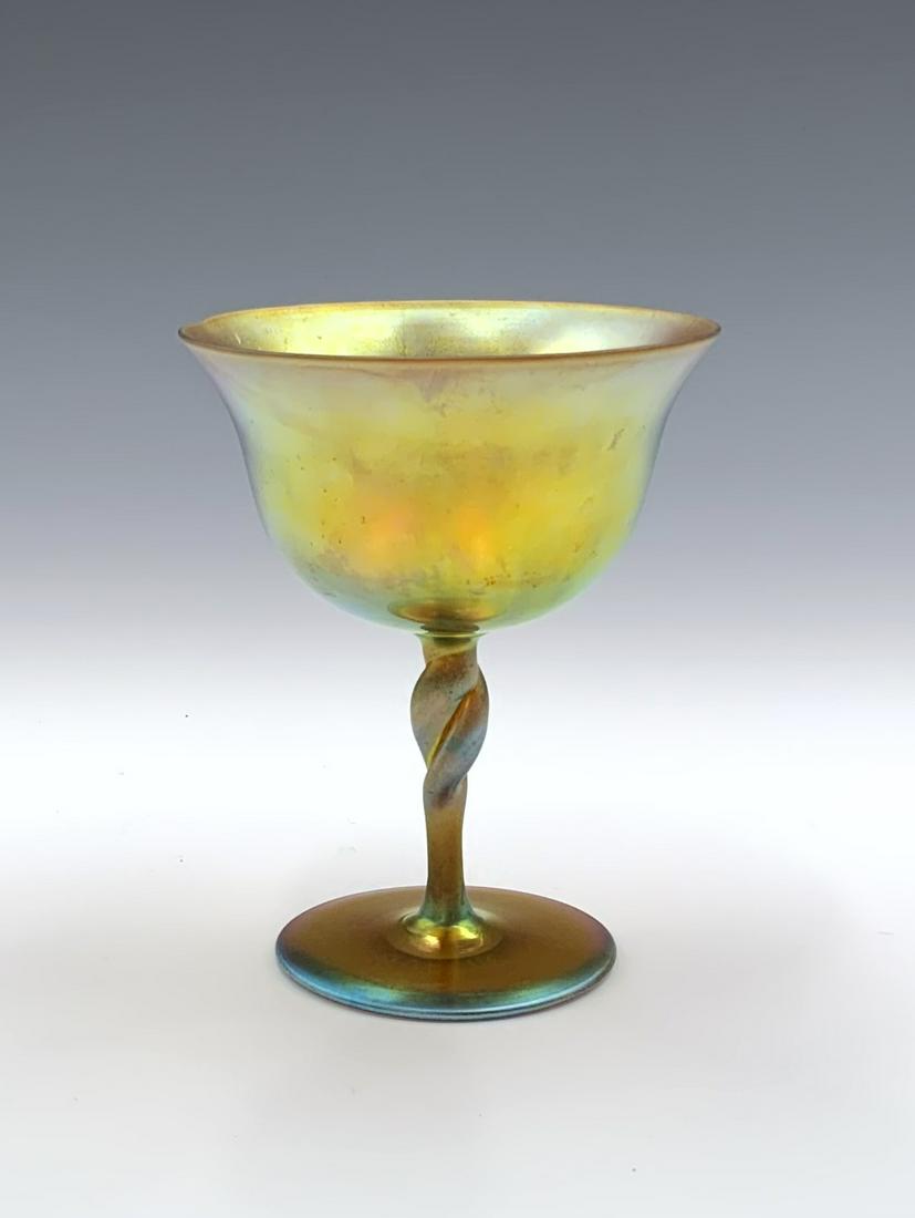 Steuben Aurene Glass Iridescent Goblet, #2361.: Marked, "Aurene 2361" on the Underside. The Goblet Looks to be in Nice condition overall, with some wear/crackling on the iridescent finish. It measures 5" tall and 3 7/8" in diameter.