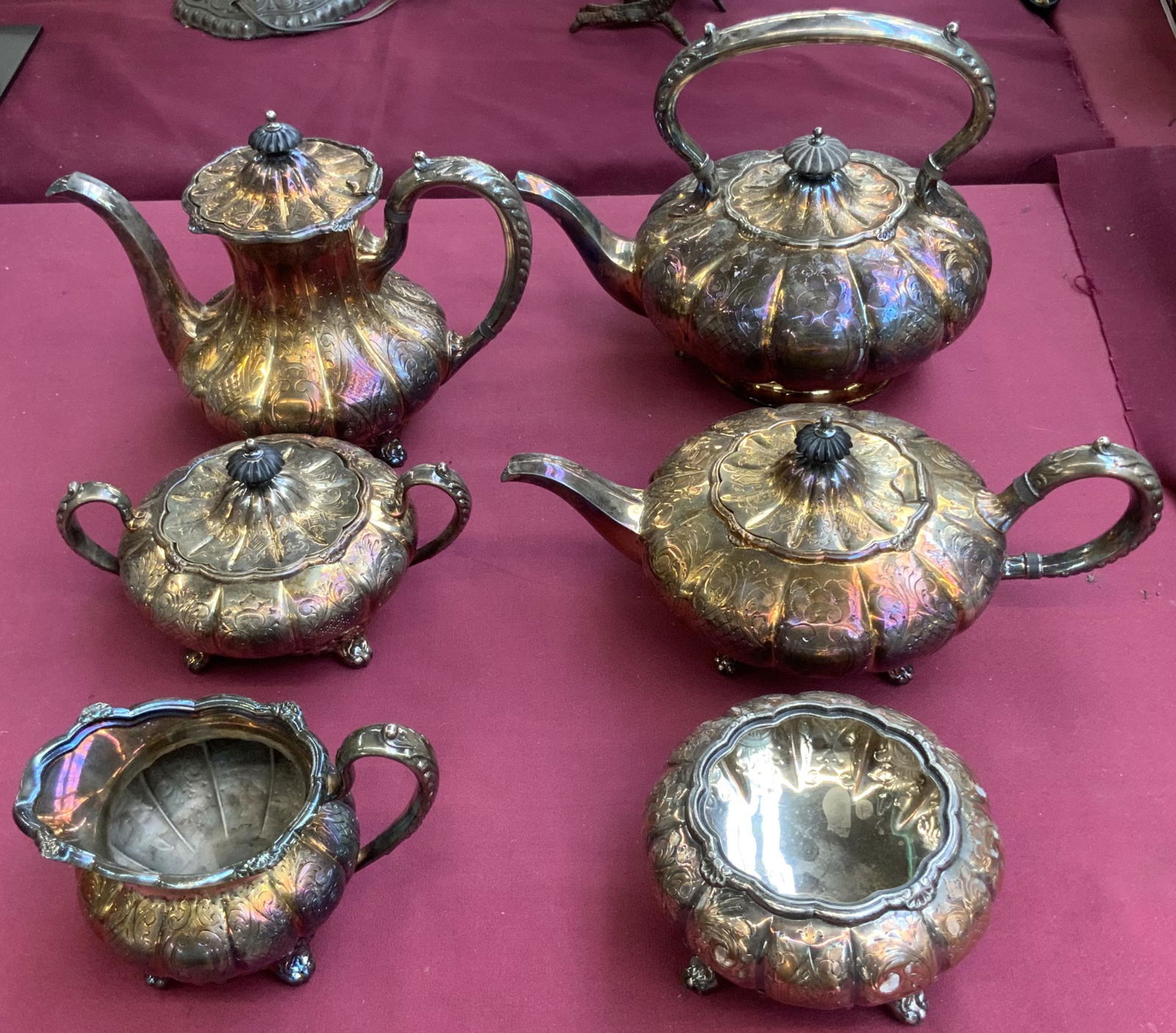 EPC Silverplate Coffee / Tea Service Set.: Silver over copper. All are footed, except for the largest teapot, which looks like it is meant to attach to a burner. The Set includes three pots, a sugar bowl, a creamer jug, and a waste bowl. The l