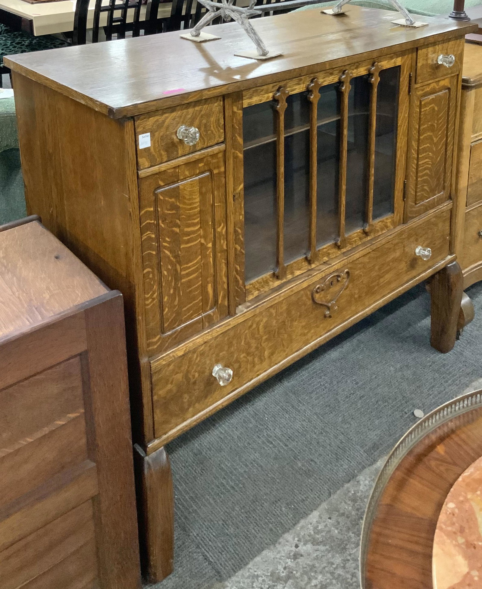 Antique Quarter Sawn Oak Sideboard Buffet: A Small-size buffet which has a glass door in the front, Two small drawers, and a large drawer on the bottom. Originally, there was a back splash rail, not present now. The overall condition is good, 