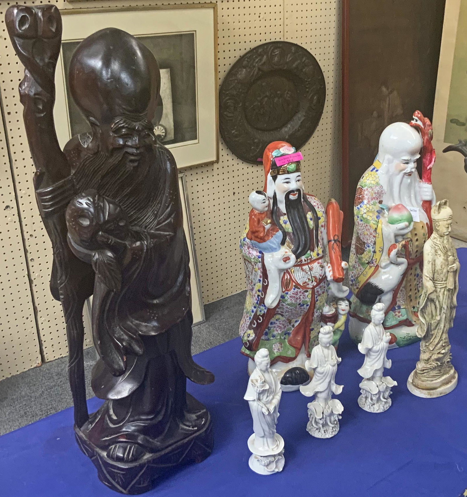 Lot: 7 Pcs.: Chinese Wood Figure & Other Figurines: The Largest Figure is Wood, and measures 23 1/2" Tall. It has some Nicks. There are 3 Blanc de Chein Figures, 7 1/4" Tall. Also, there are 2 Porcelain Man Figurines, appx. 16" Tall. Finally, there is 