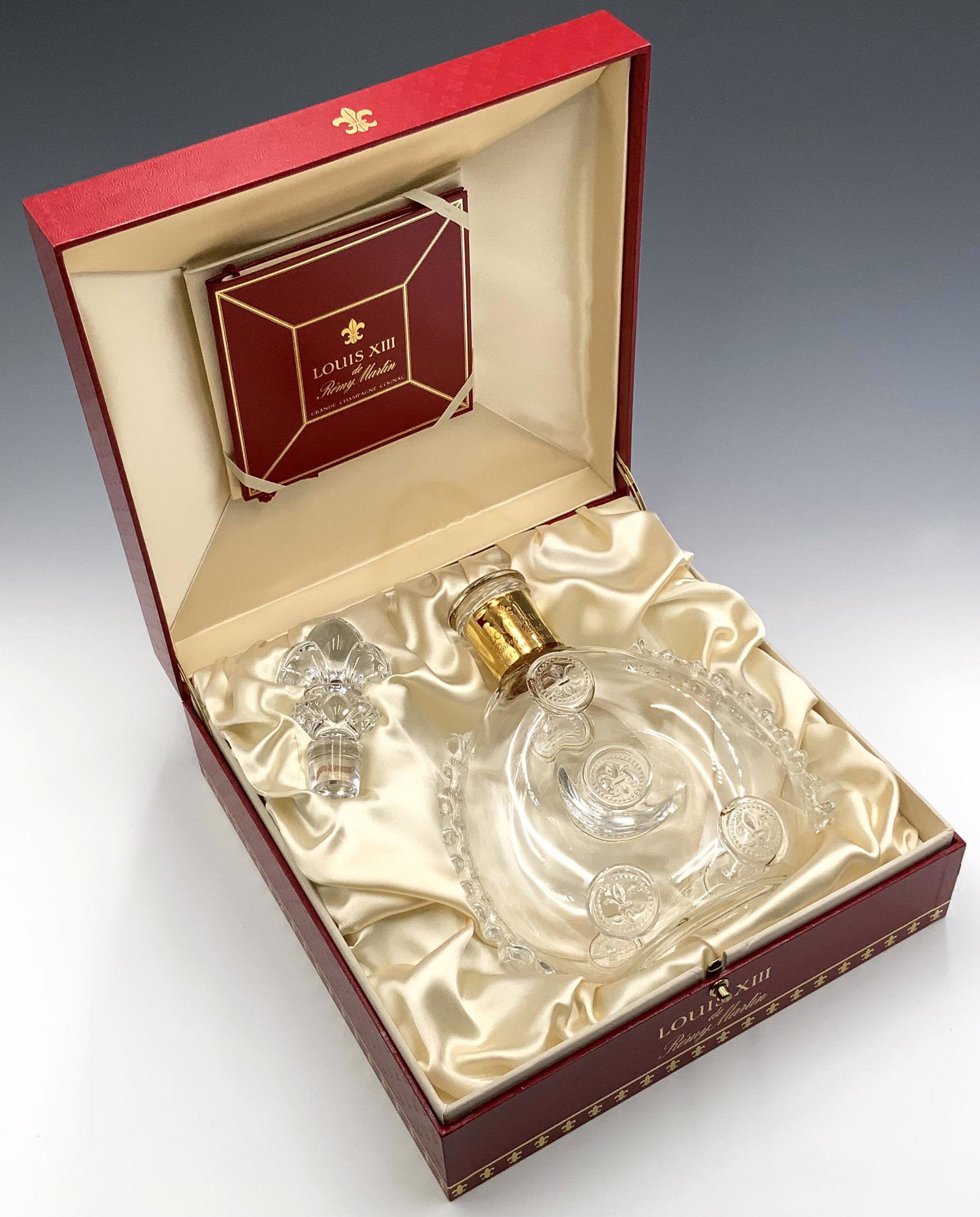Remy Martin Louis XIII Baccarat Crystal Bottle.: With the stopper and original box. The Cognac bottle is empty, and appears to be in Good cosmetic condition. It measures 8" tall. The box measures 10 1/2" x 10 1/2" x 4 1/2".