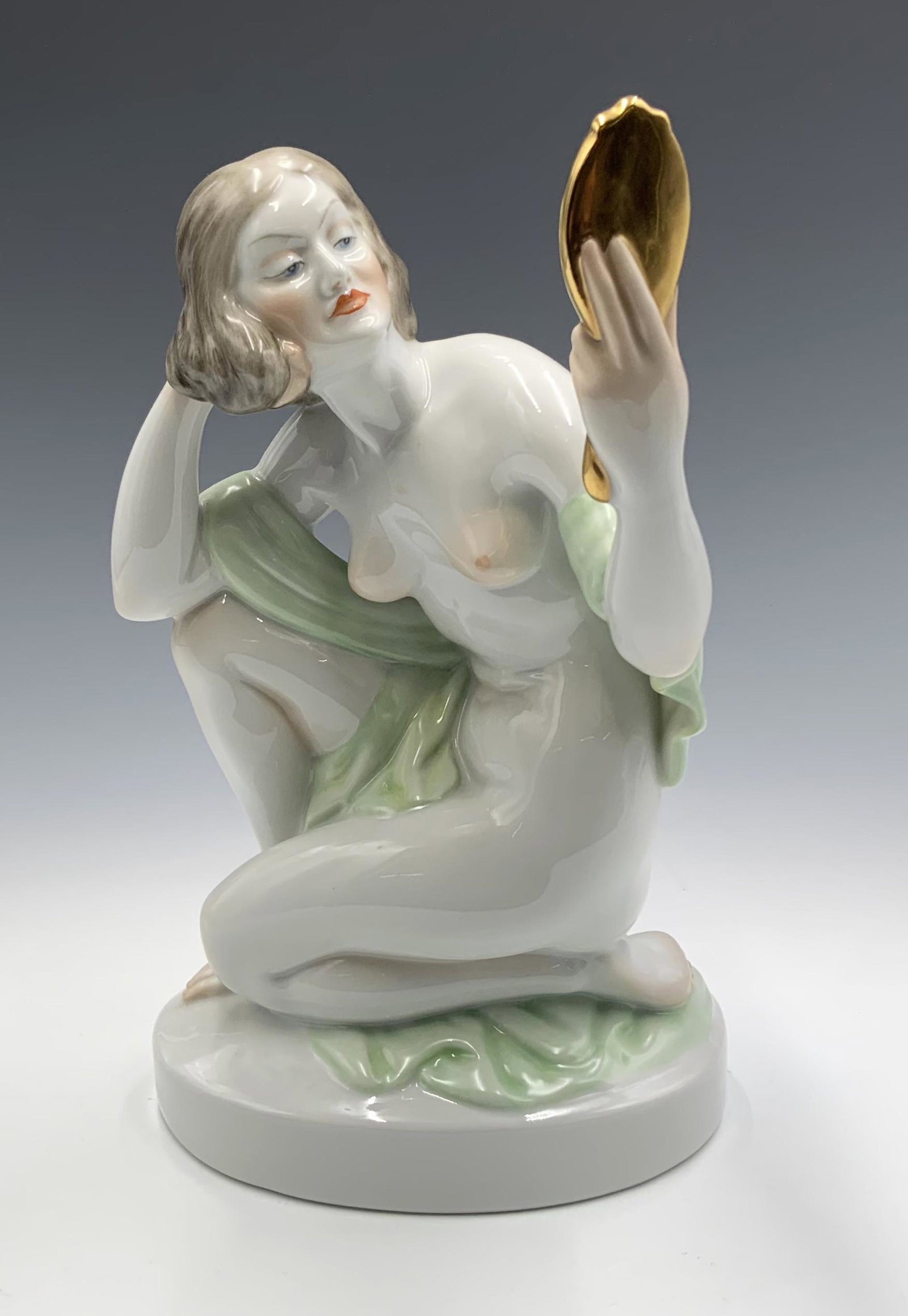 Herend Nude Female Figurine Holding a Mirror.: Marked "Herend Hungary" on the Underside. The Figure measures 9 1/2" tall, and looks to be in Great condition.