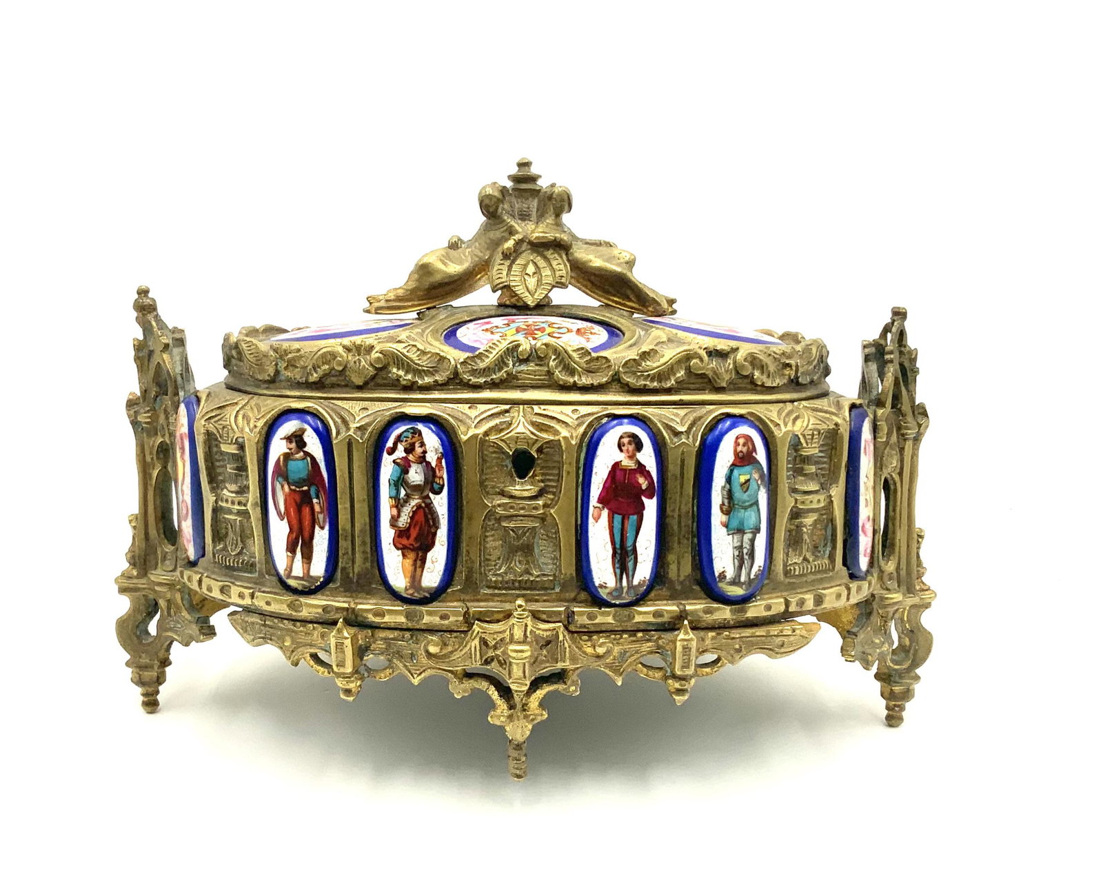 Bronze Lidded Box w/ Painted Porcelain Plaques.: An ornate curved box with four feet (one is broken). There are four coat of arm plaques on the lid, two coat of arm plaques on the front (one has been glued back on), and four royal court plaques on t