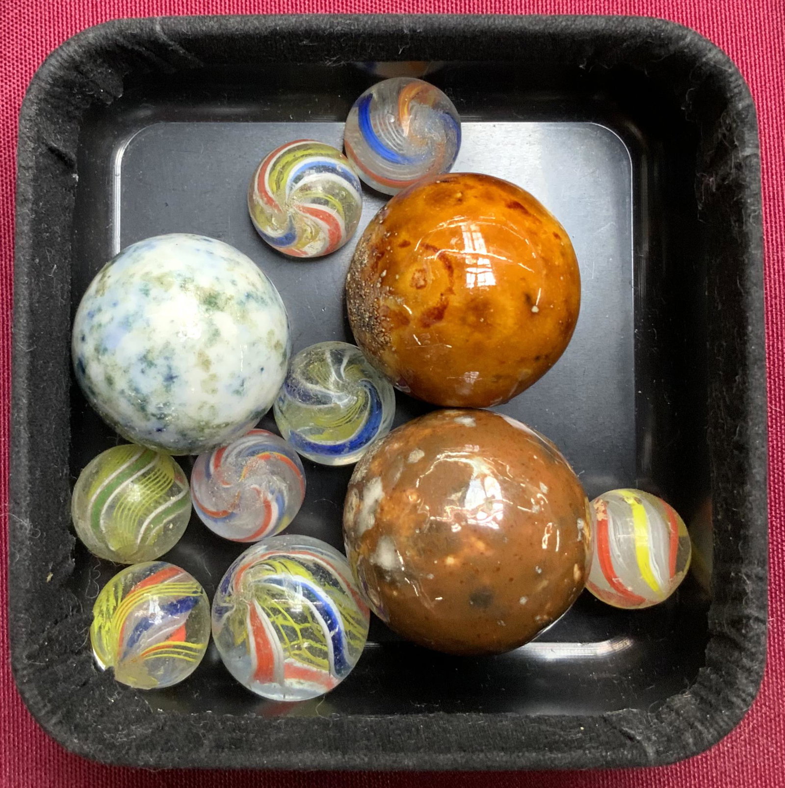 Lot of Vintage Marbles - Swirls, etc.: Also, 3 Bennington Marbles. There are Nine marbles total. There appear to be some Dings and Blemishes. The larger ones measure 1 1/4" in diameter.