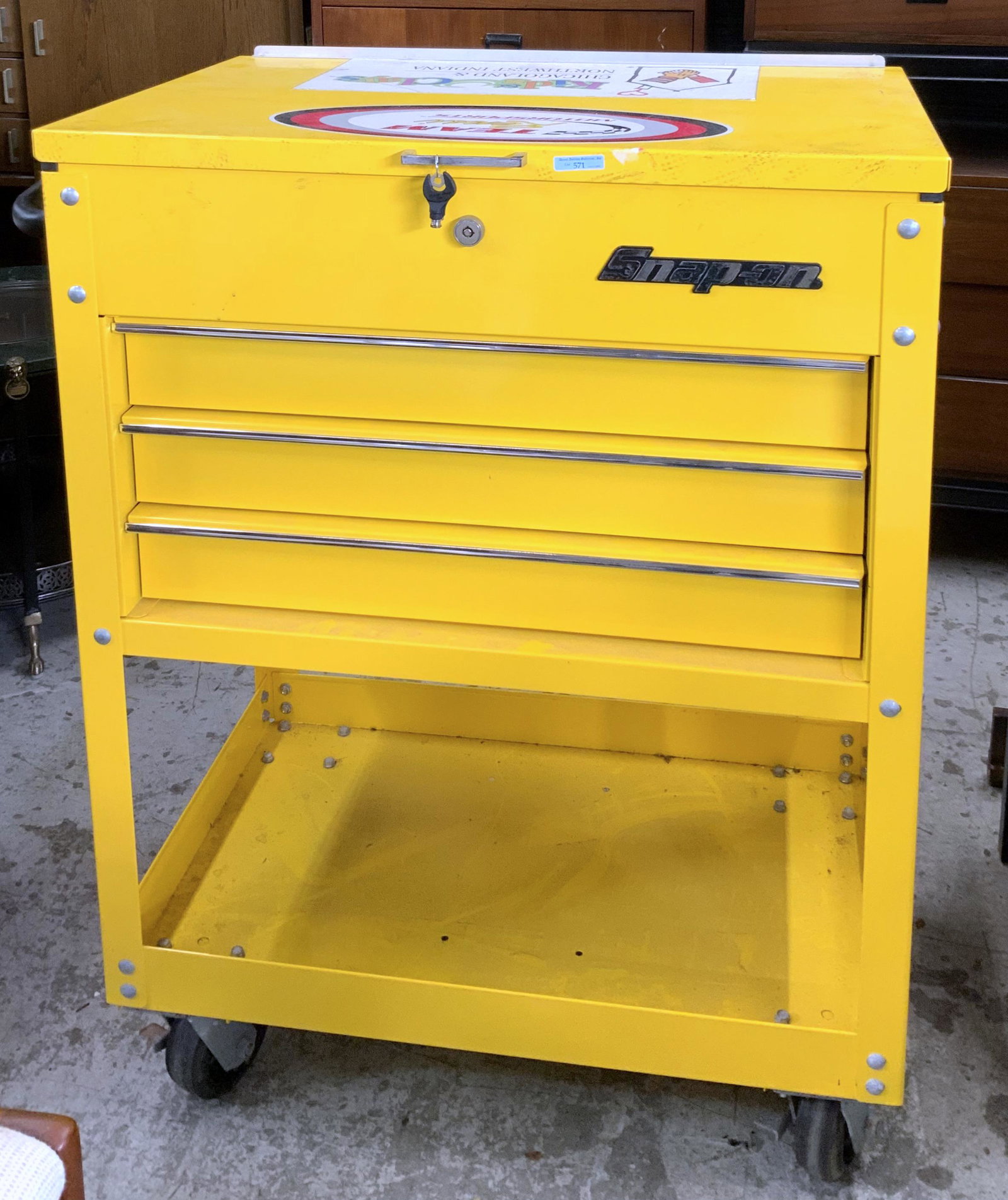 Snap-On Rolling Mechanic's Tool Chest.: This yellow chest has a large top compartment with 3 locking drawers, and a tool storage area in the bottom. There is a locking mechanism with the key. The interior is clean and has had very little us