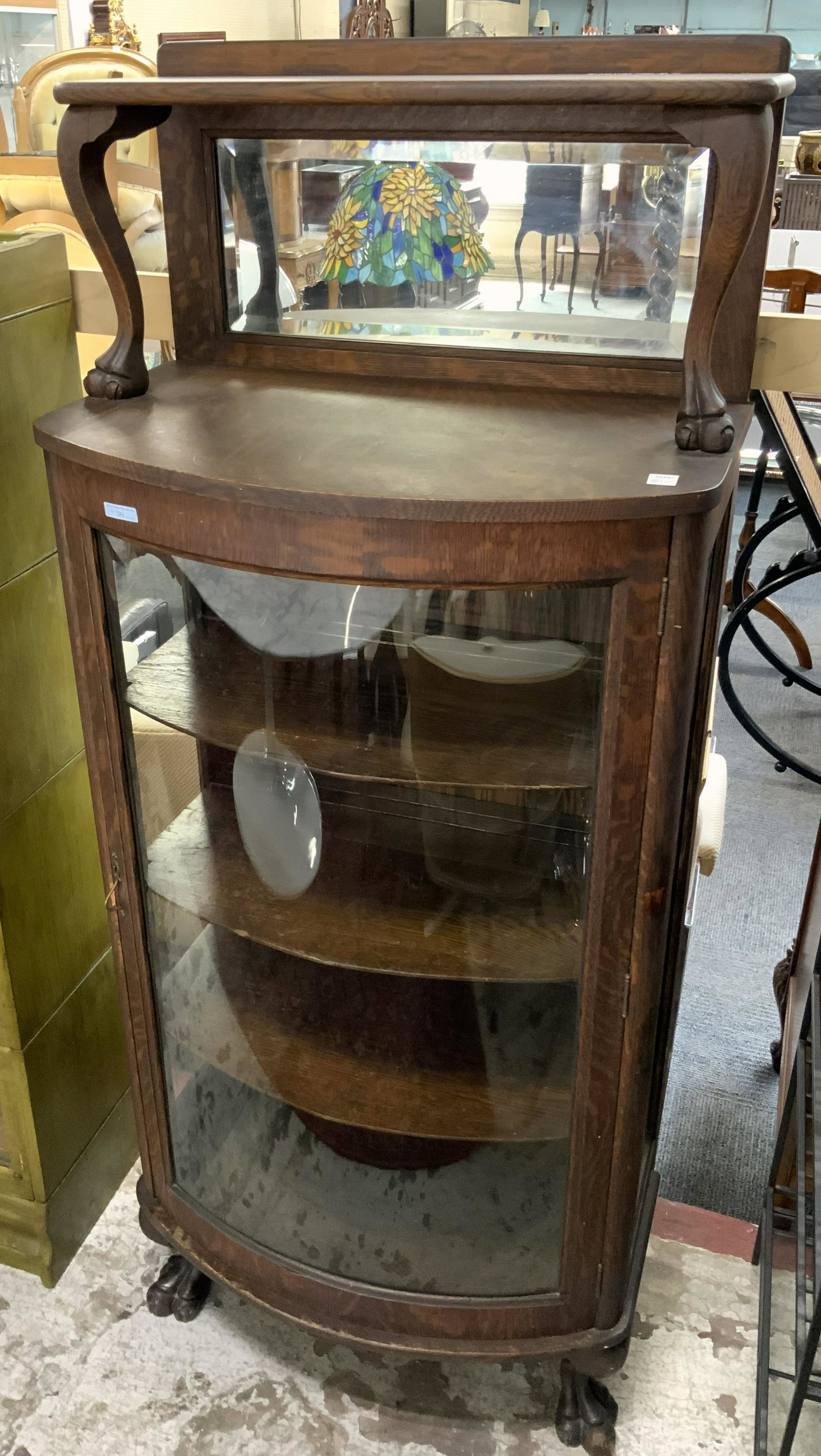 Petite Round Oak China Cabinet with Mirror.: This small-size curved glass oak china cabinet appears to be in good overall condition. It has the original finish which is intact. However , there is a small scuff near the lock on the door frame. Th