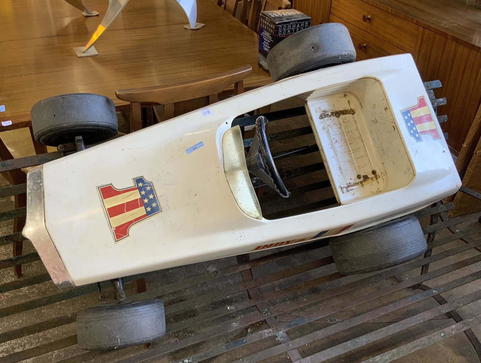 "Indy Jr." Child's Toy Pedal Car.: The Car Looks like it has seen Quite a Few Races - and a Few Minor Crashes. There is Light Rust, Scratches, and some Serious Scuff Marks on the Front of the Vehicle. It measures 44" Long. Third-Party